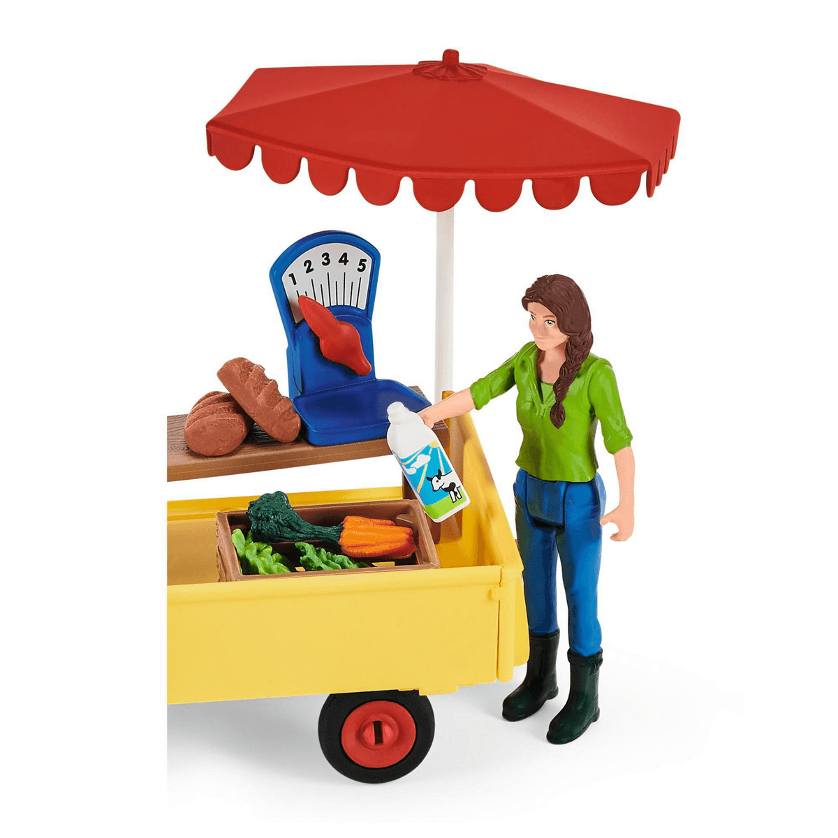 Una figura de vendedor junto a un puesto amarillo con sombrilla roja, pan, verduras y leche.