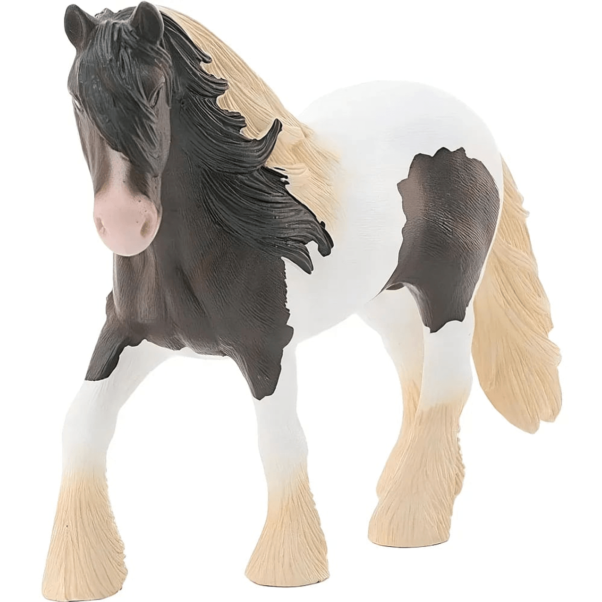 Une figurine de cheval Tinker avec une tête noire, un corps blanc, des taches sombres et une crinière blonde.