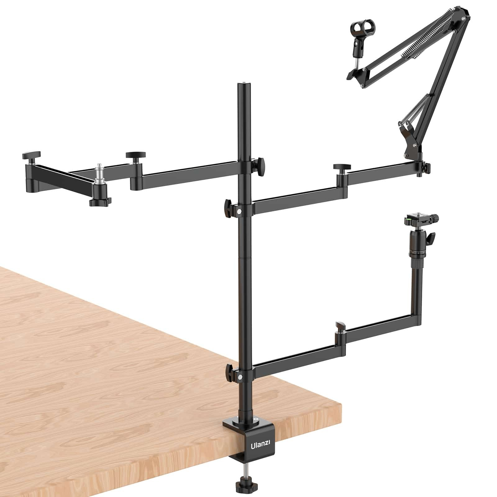 Un support de bureau noir articulé avec plusieurs bras et fixations est fixé au bord d'une table en bois.