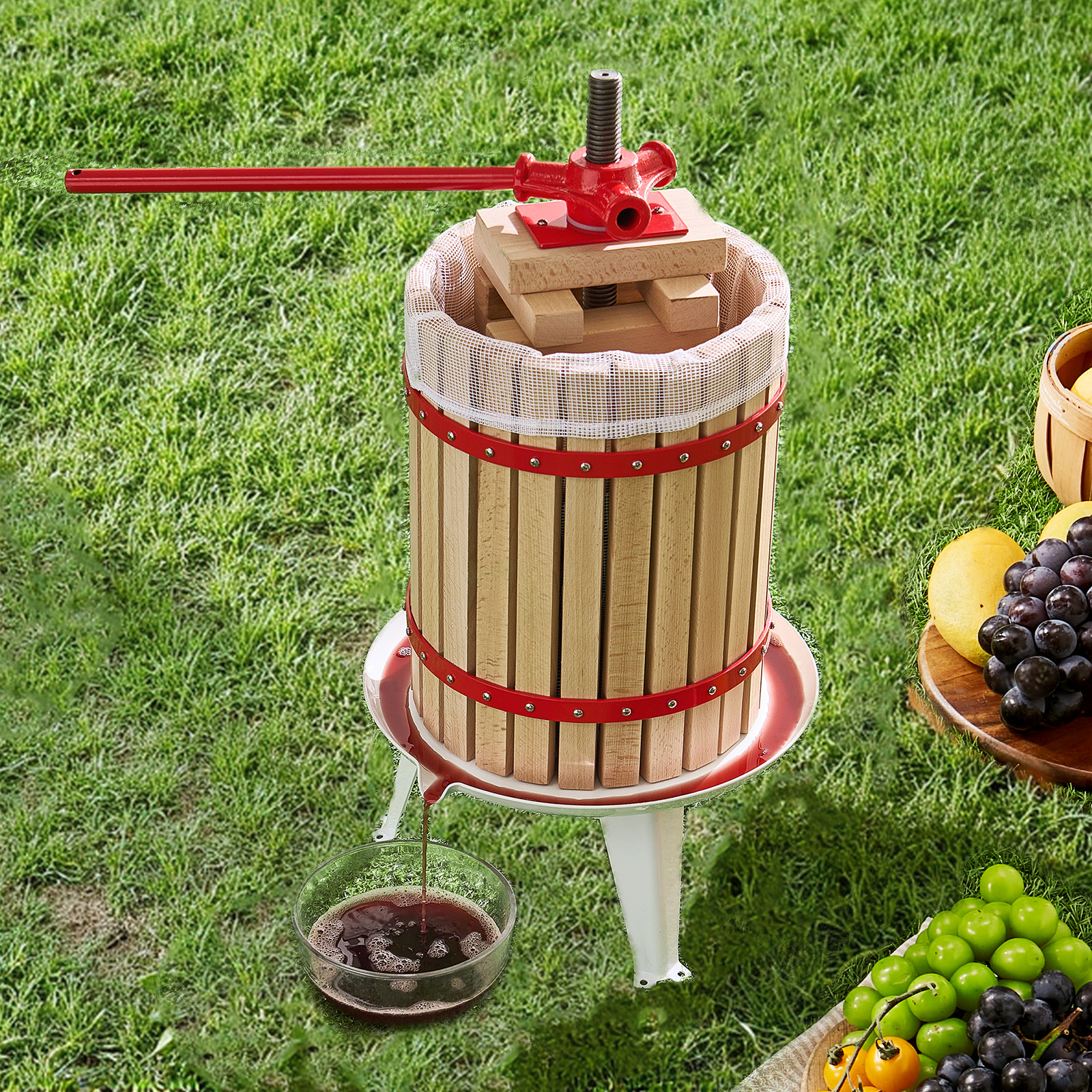 Una prensa de fruta de madera en el césped exprime jugo en un tazón.