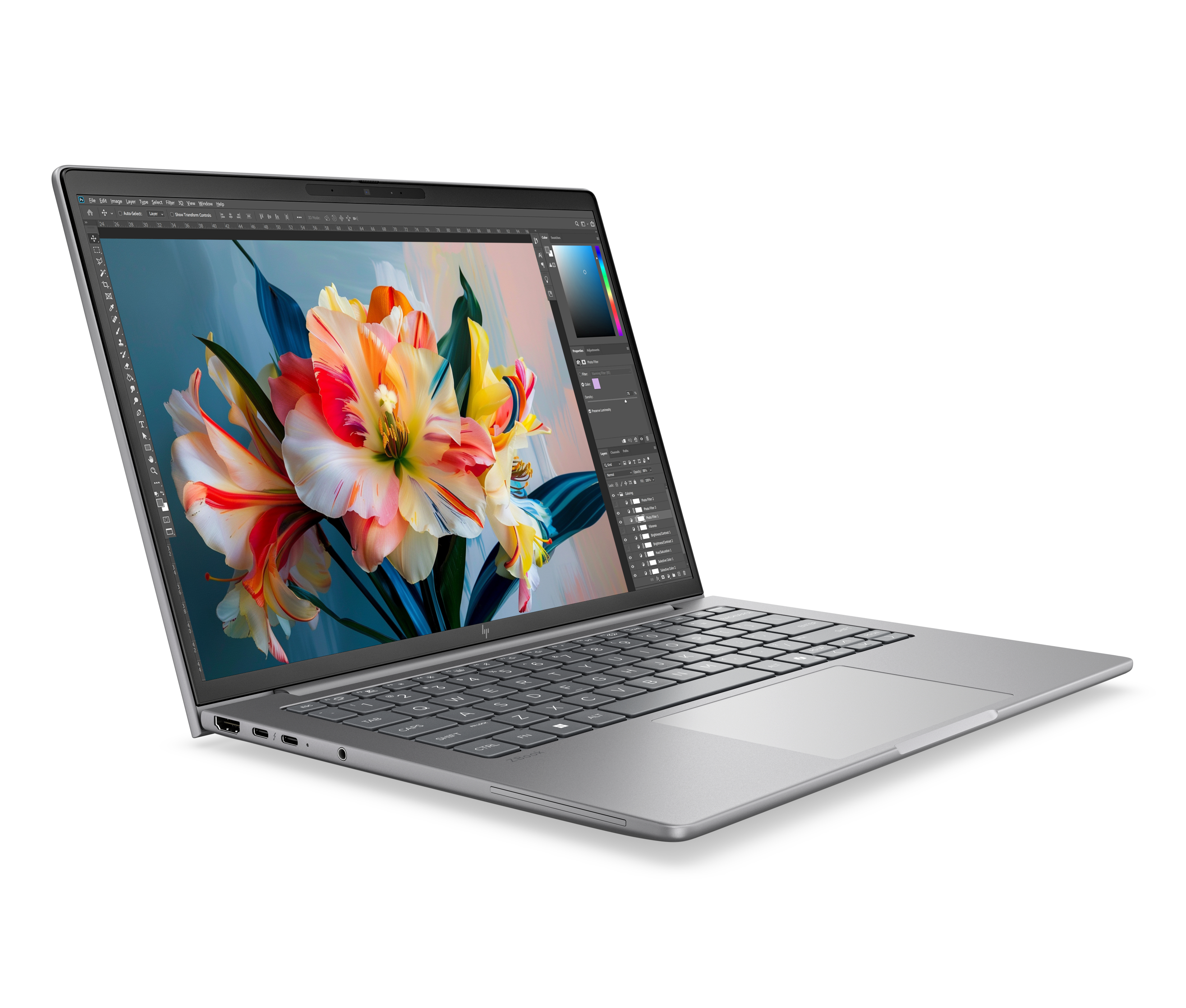 A silver laptop with an open screen showing flowers and photo editing software.