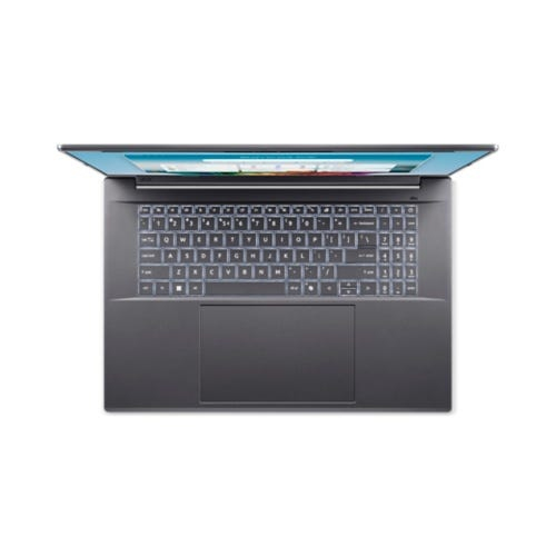 Vue de dessus d'un ordinateur portable sombre avec clavier rétroéclairé et grand pavé tactile.