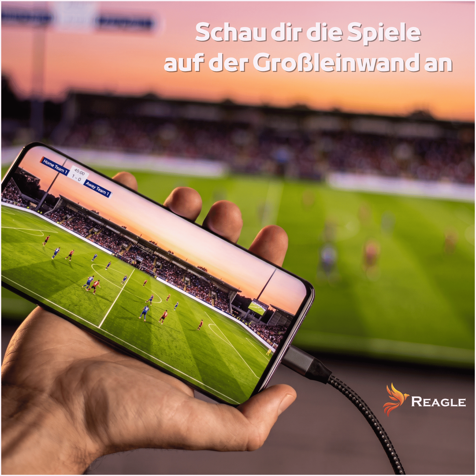 Dłoń trzyma smartfon z transmisją meczu piłki nożnej, w tle rozmyty stadion.