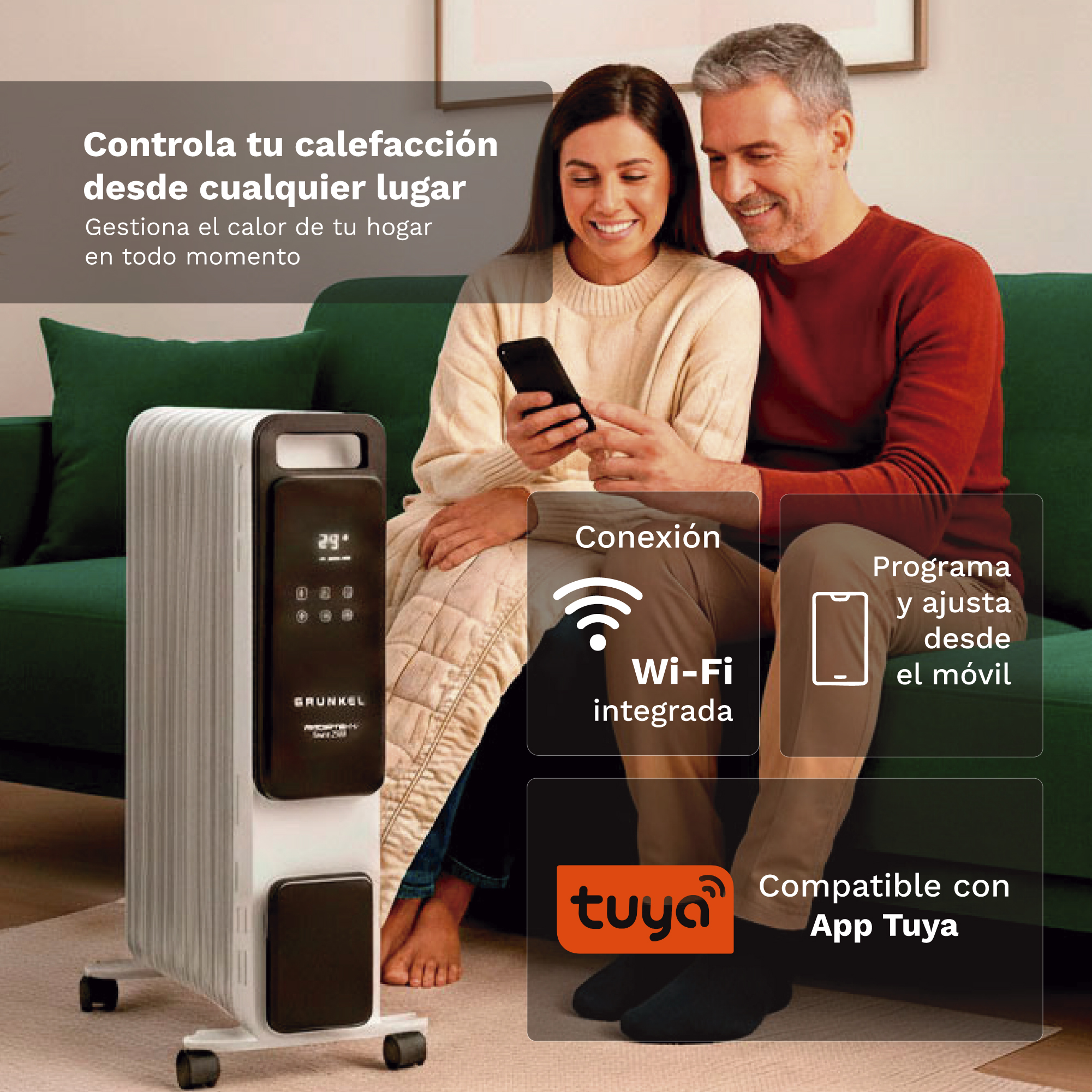 Una pareja en un sofá verde usa un móvil junto a un radiador eléctrico inteligente.