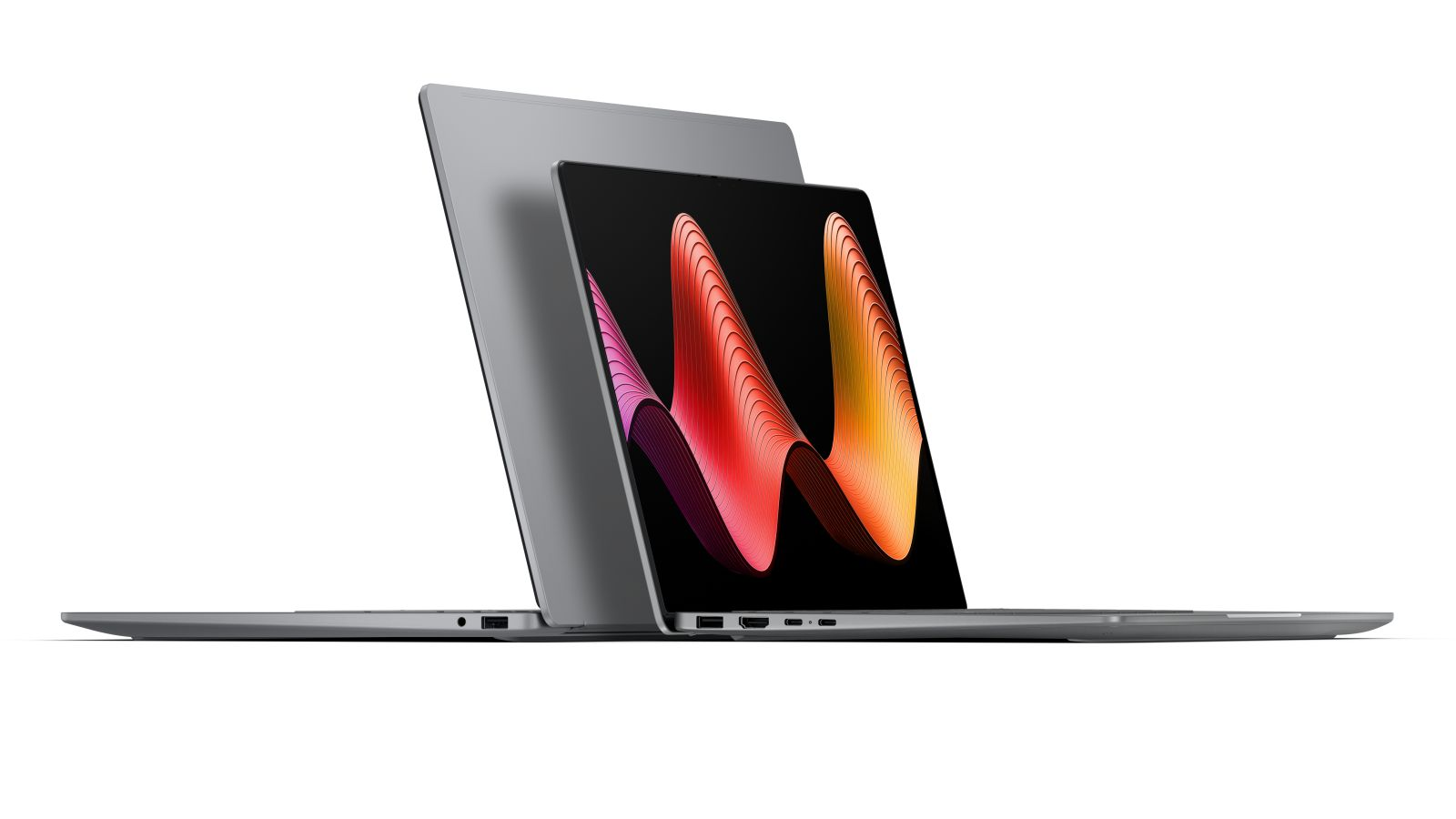 Zwei graue Laptops überlappen auf einer weißen Oberfläche und zeigen ein abstraktes Wellen-Hintergrundbild.
