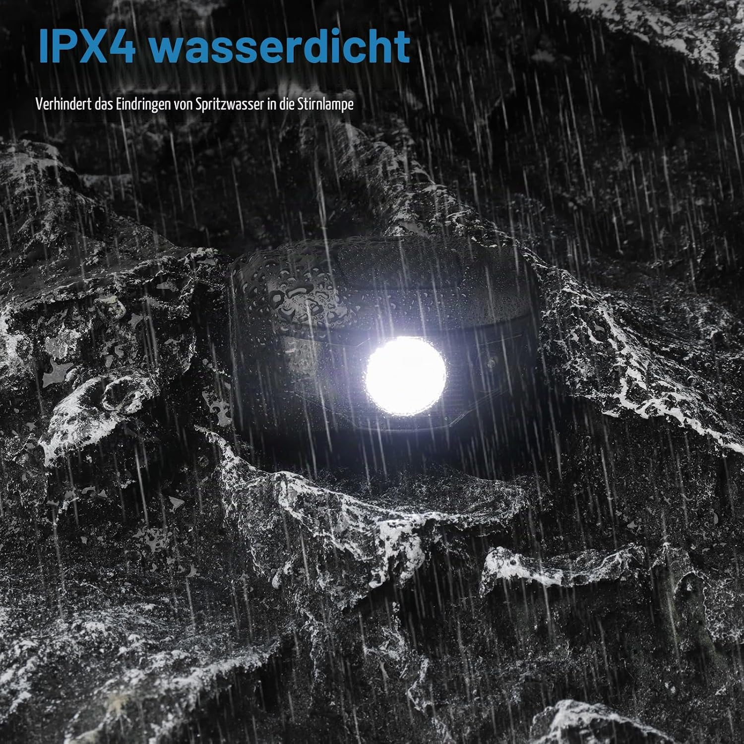 Eine schwarze Stirnlampe leuchtet im Regen vor felsigem Hintergrund.