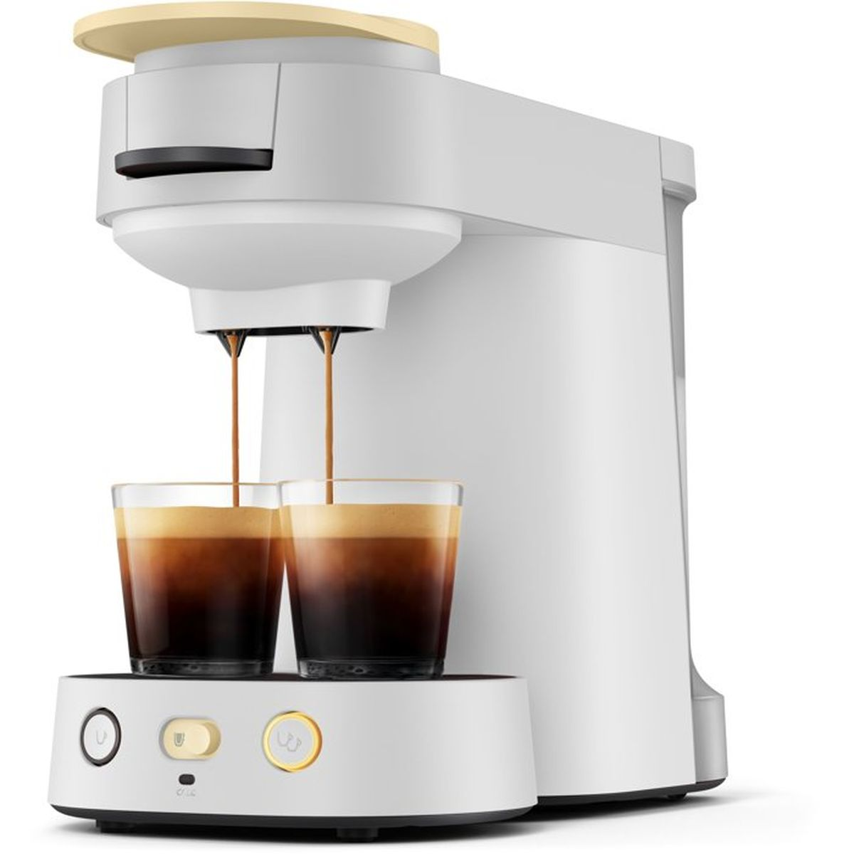 Eine weiße Kaffeemaschine gießt Kaffee in zwei Glasbecher auf einem beleuchteten Sockel.