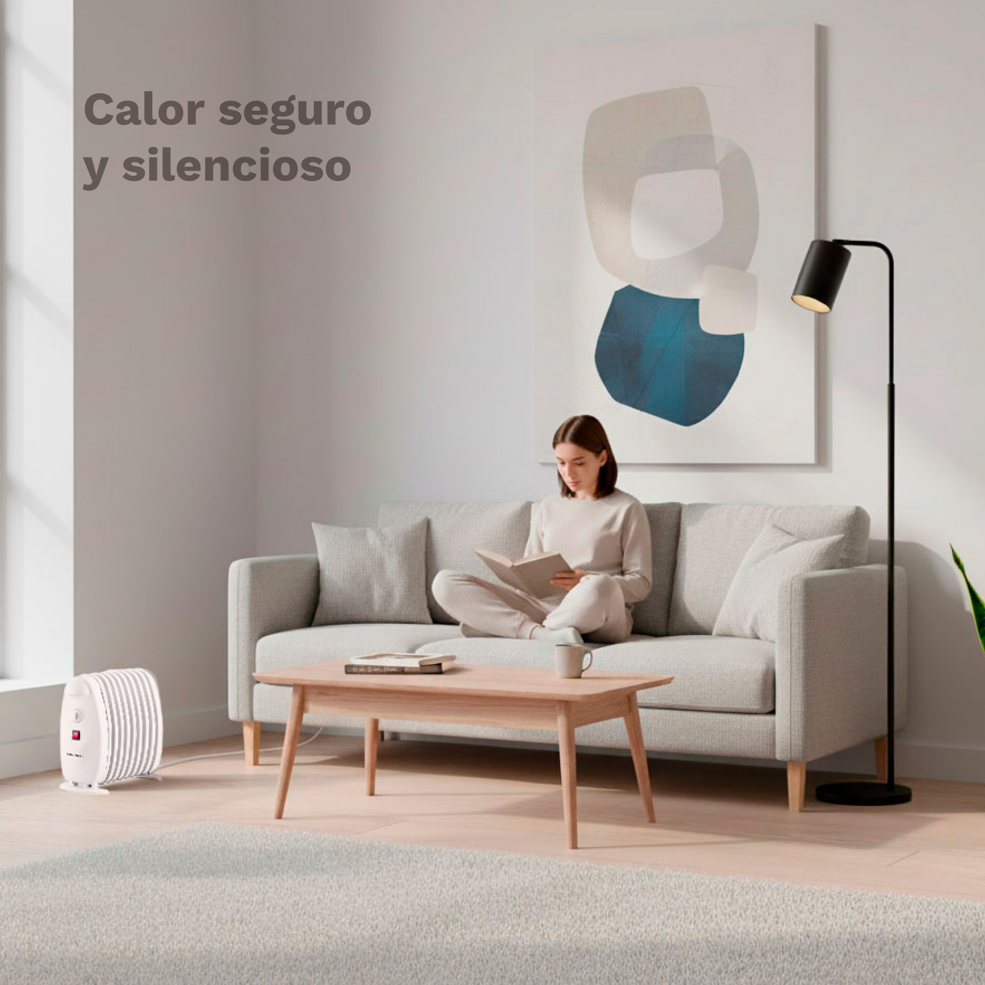 Una mujer lee en un sofá gris en una sala acogedora con un calefactor.