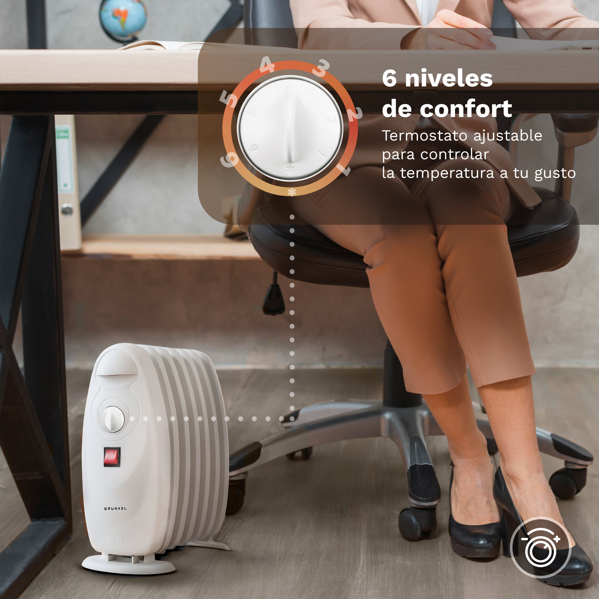 Pequeño radiador de aceite blanco bajo un escritorio con una mujer sentada.
