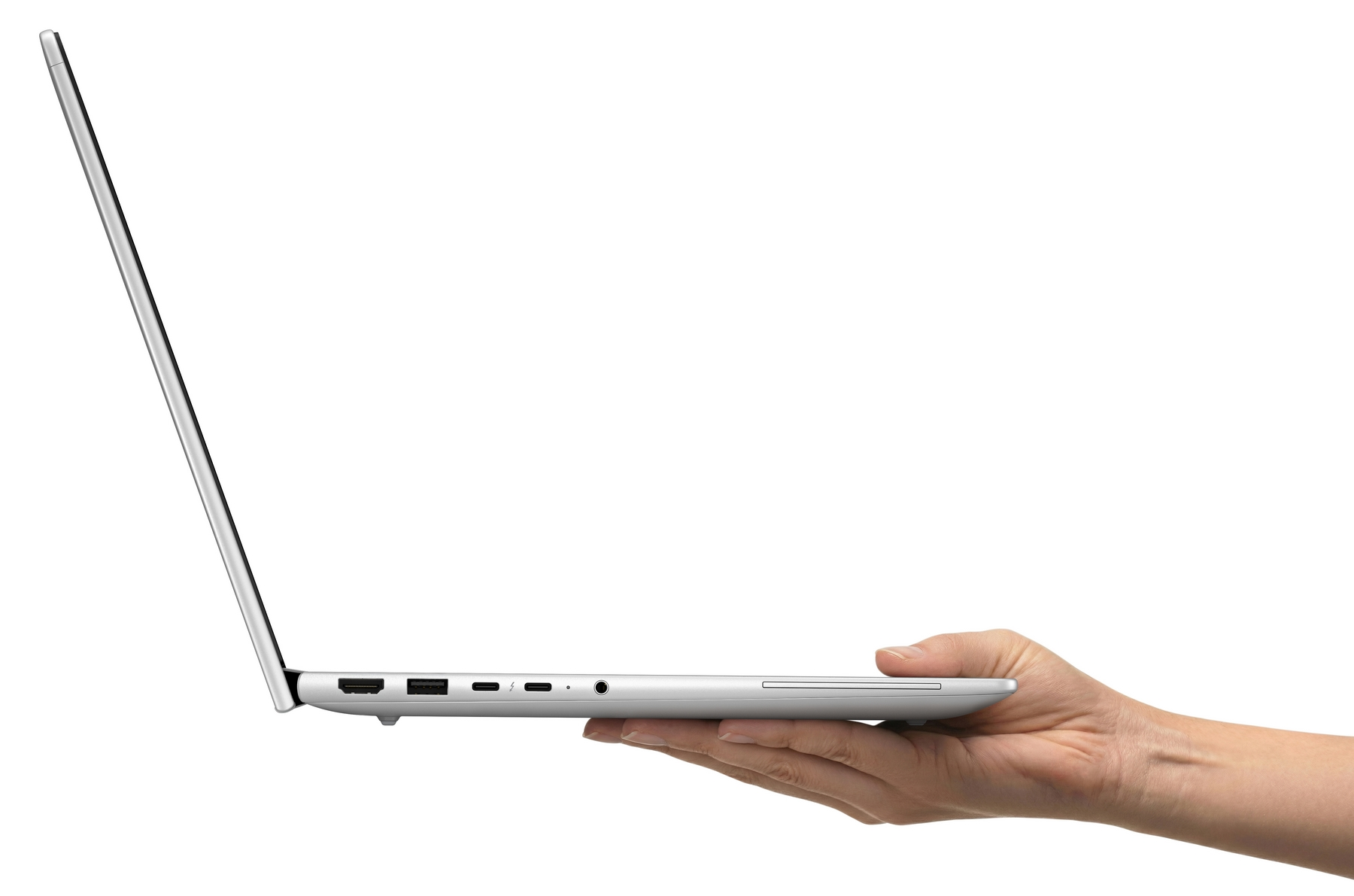 Una mano sostiene un computer portatile argentato di lato su sfondo bianco.
