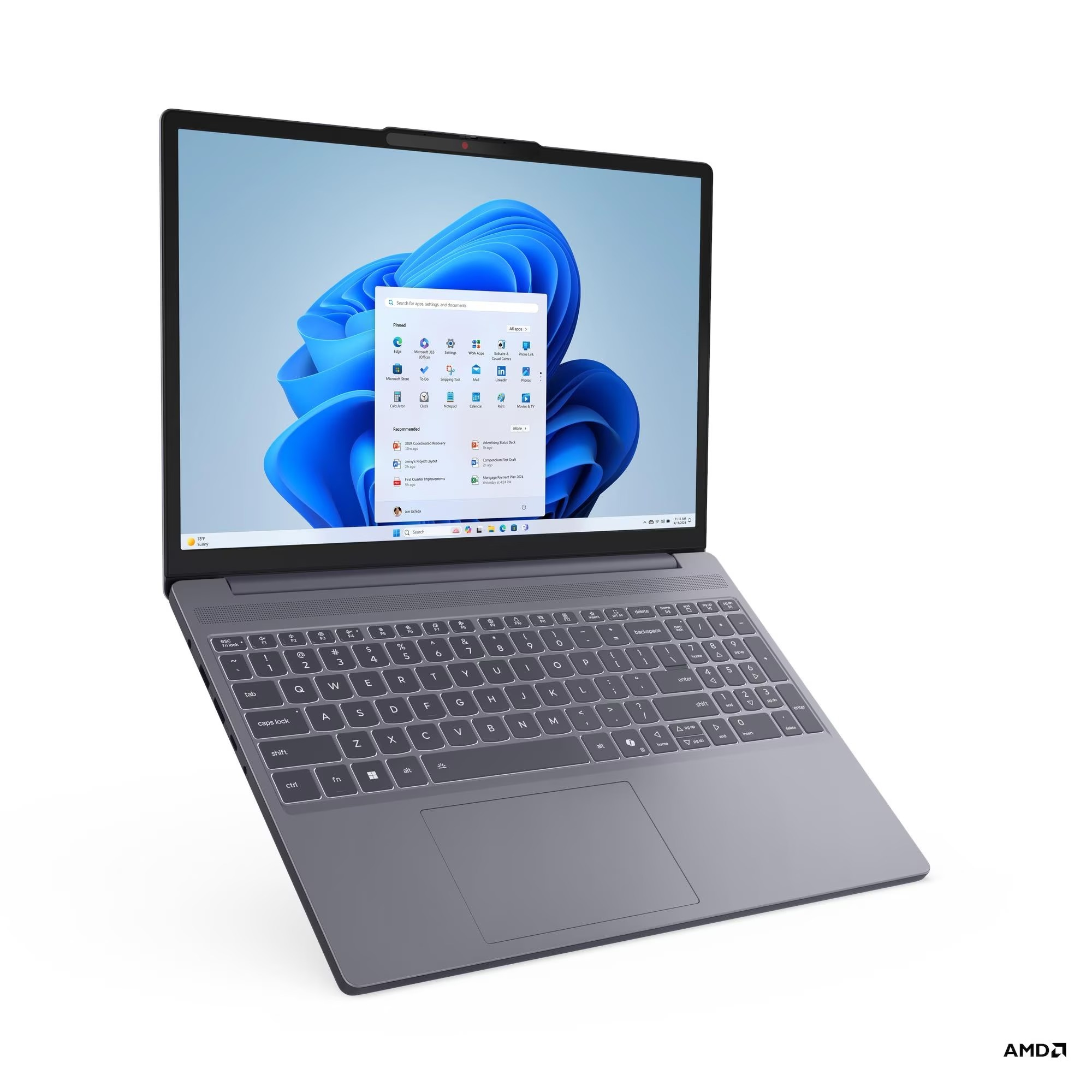 Beyaz arka planda gri bir dizüstü bilgisayar, mavi çiçekli Windows masaüstünü gösteriyor.