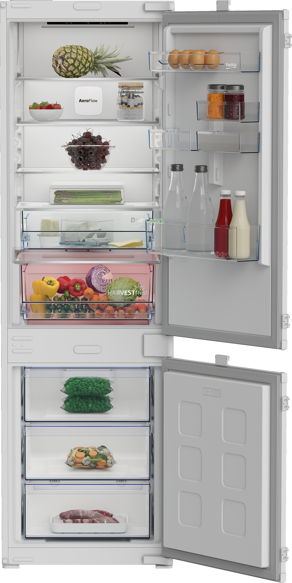 Un refrigerador blanco abierto lleno de alimentos como frutas, verduras, bebidas y productos congelados.