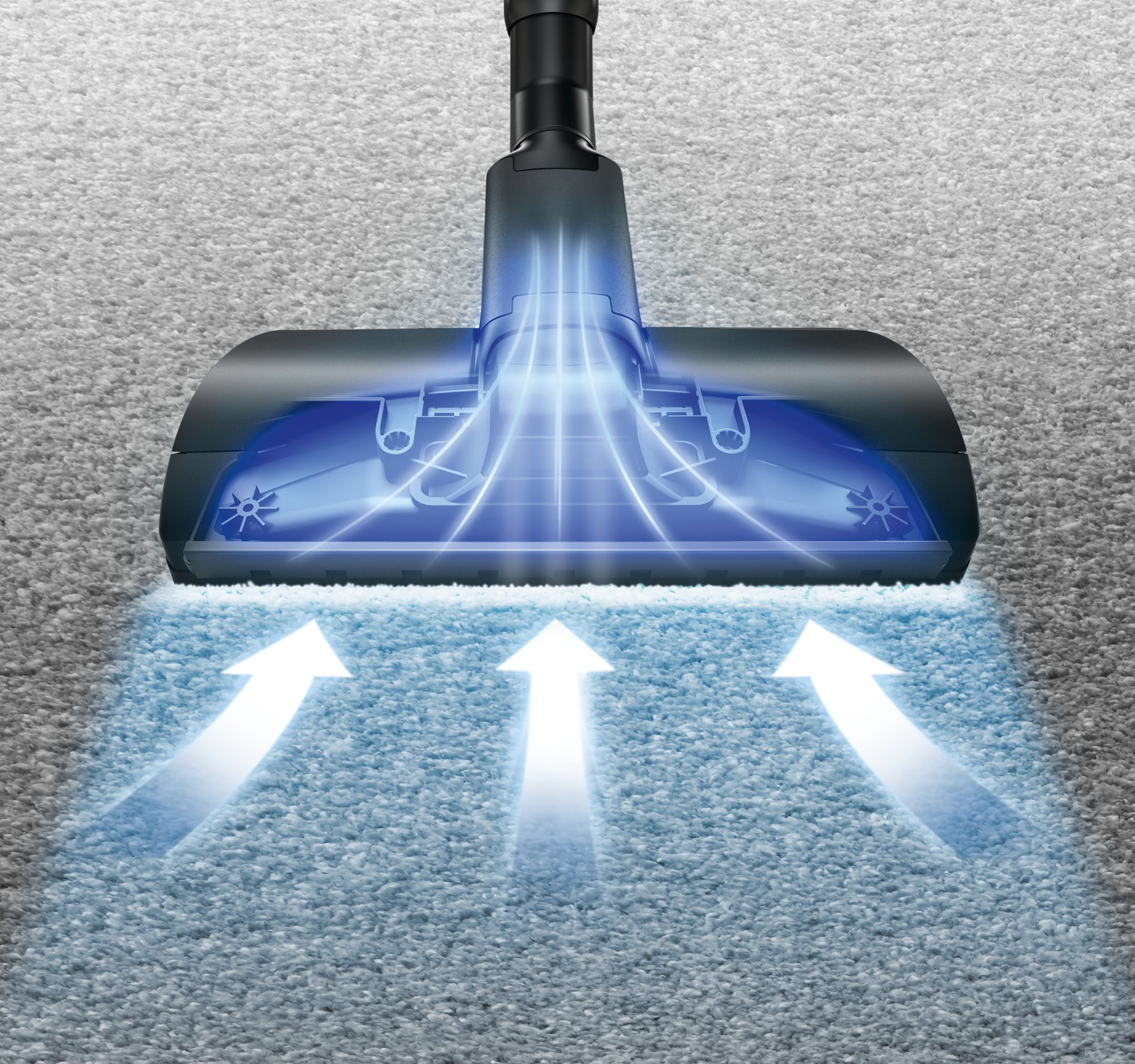 Cabezal de aspiradora sobre alfombra gris con rayos de luz azul que muestran el flujo de aire y la succión.