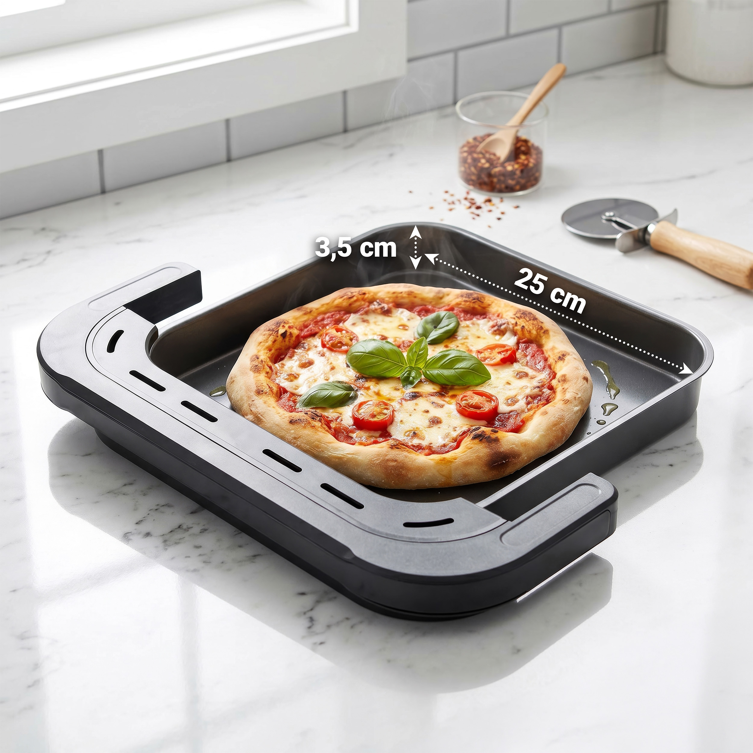 Una pizza fresca con basilico in una teglia quadrata con indicatori di misura, su un piano di lavoro bianco.