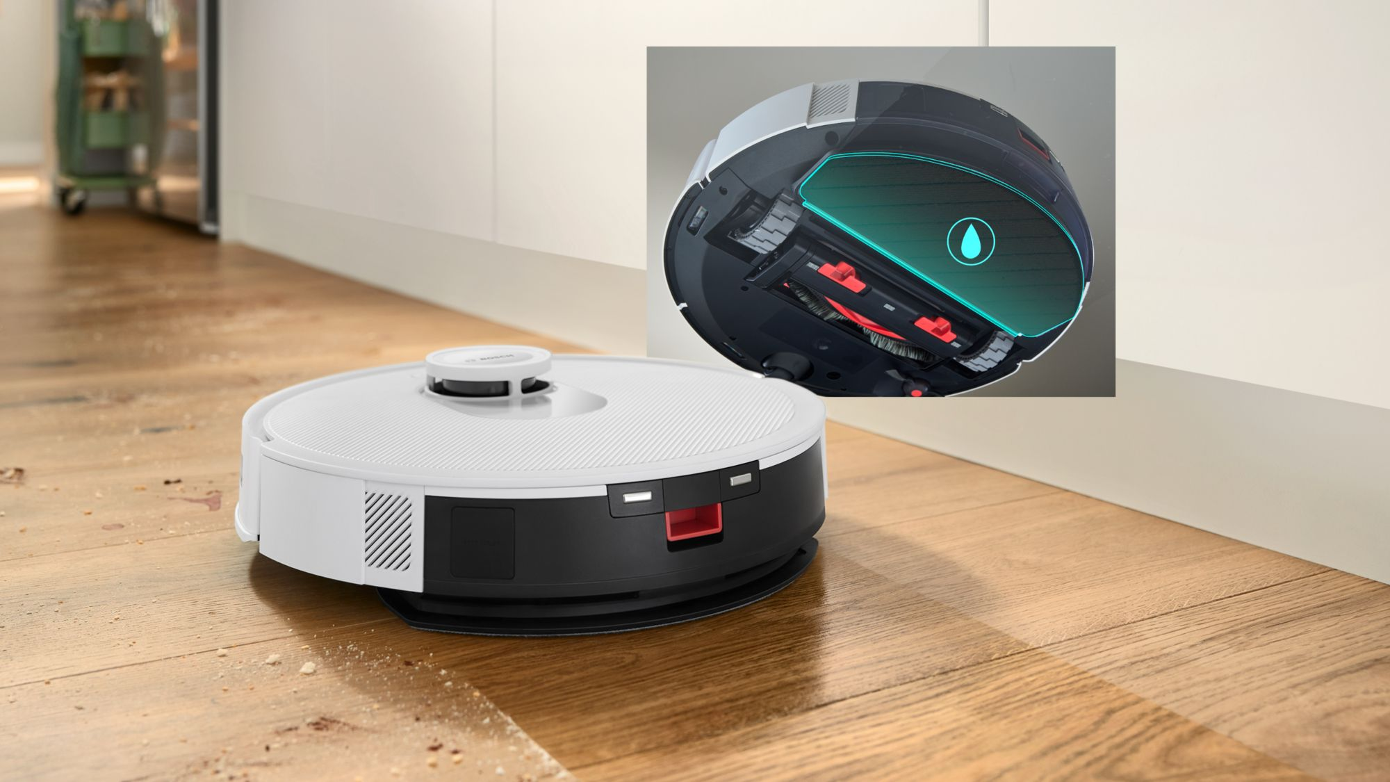 Un robot aspirador blanco y negro en suelo de madera, con un recuadro que muestra su parte inferior.