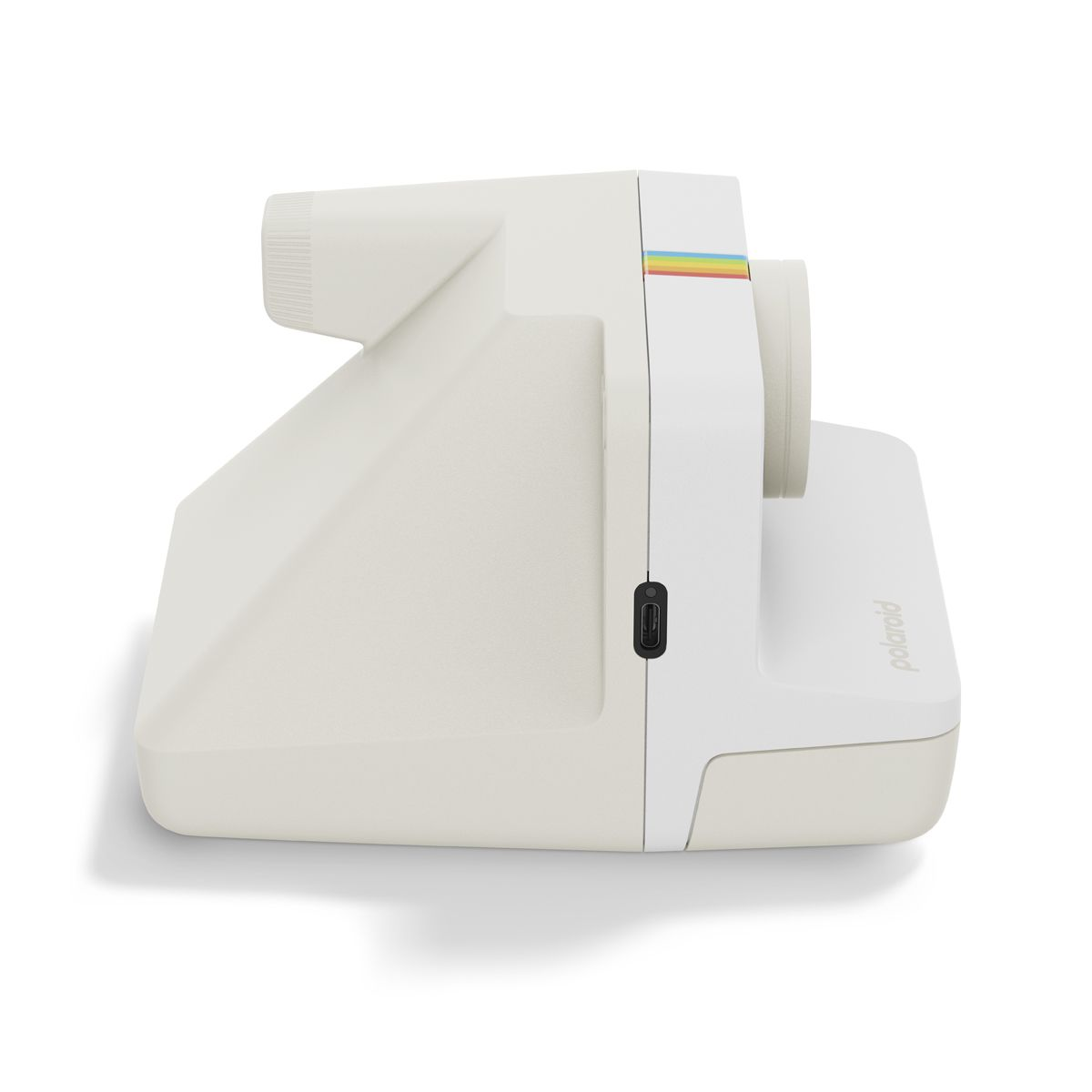 Un appareil photo instantané Polaroid blanc vu de profil sur fond blanc.