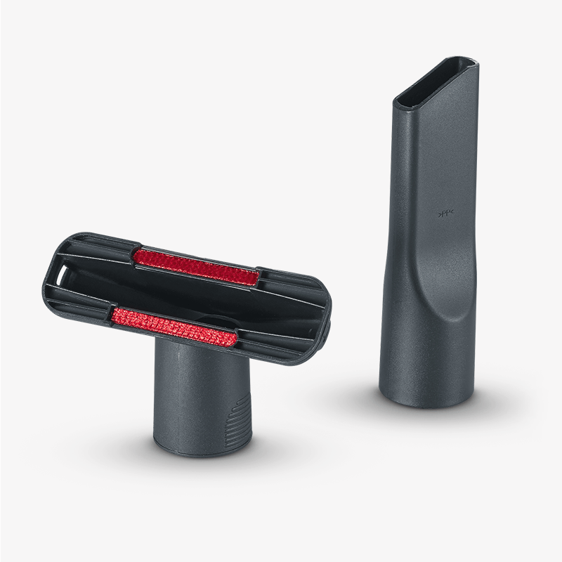 Dos accesorios negros para aspiradora sobre fondo gris, uno con franjas rojas.