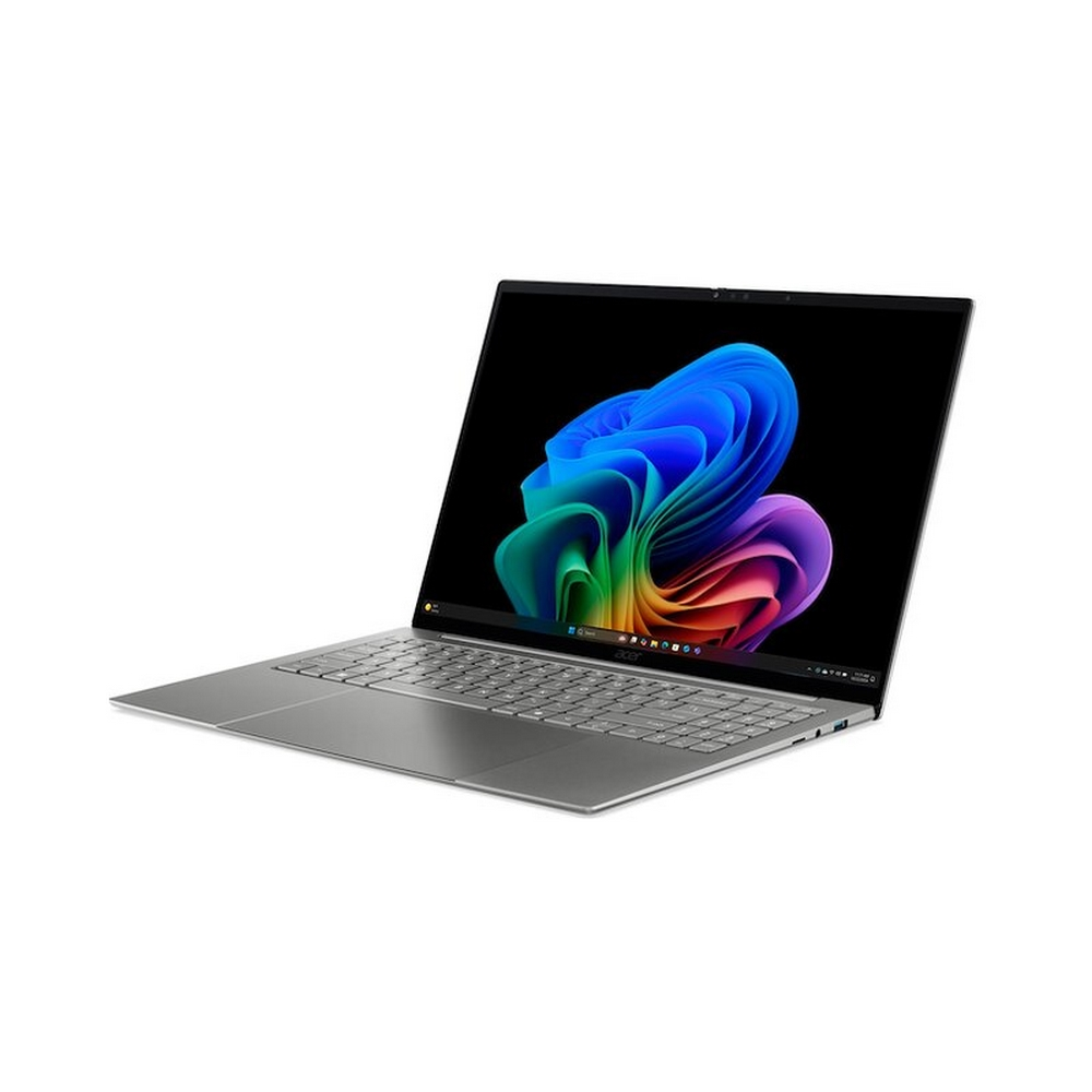 Un computer portatile argentato con schermo nero che mostra una grafica astratta colorata.