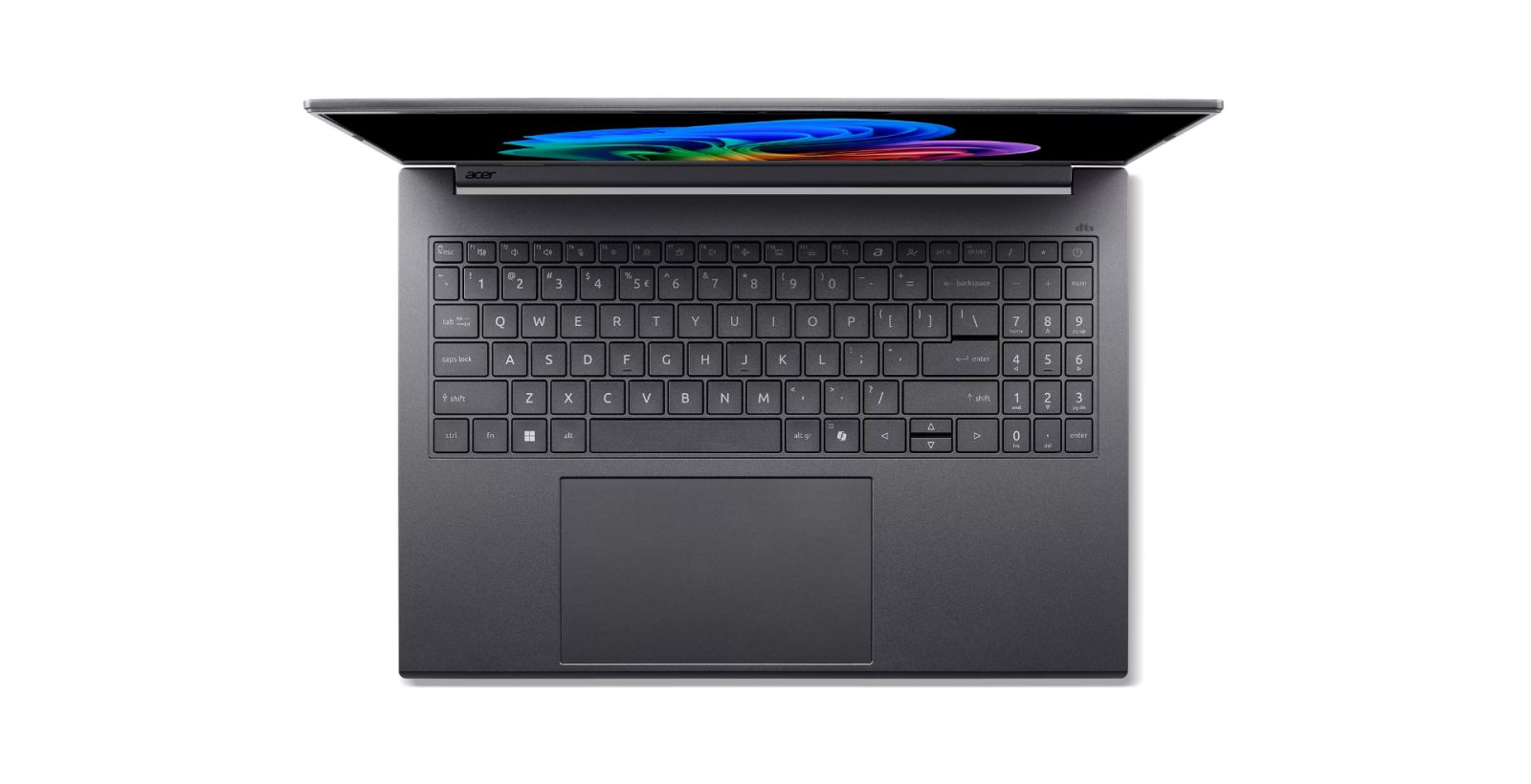 Vista dall'alto di un laptop grigio con schermo illuminato e tastiera con tastierino numerico su sfondo bianco.