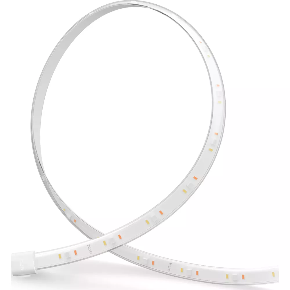 Striscia luminosa LED bianca e flessibile arrotolata in un anello con piccoli chip visibili su sfondo chiaro.