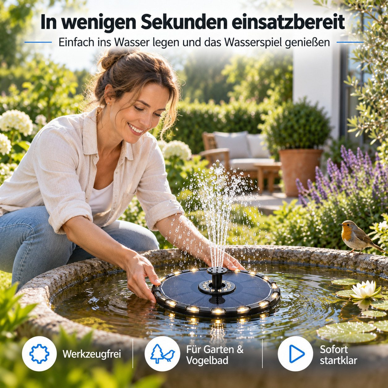 Eine Frau platziert einen solarbetriebenen Springbrunnen mit Lichtern in einem Gartenbrunnen.