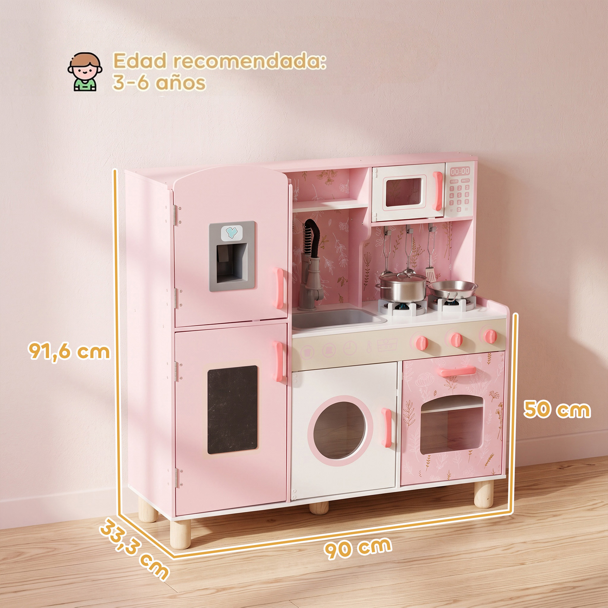 Una cocinita de juguete de madera rosa y blanca con dimensiones, microondas y utensilios en un suelo de madera.
