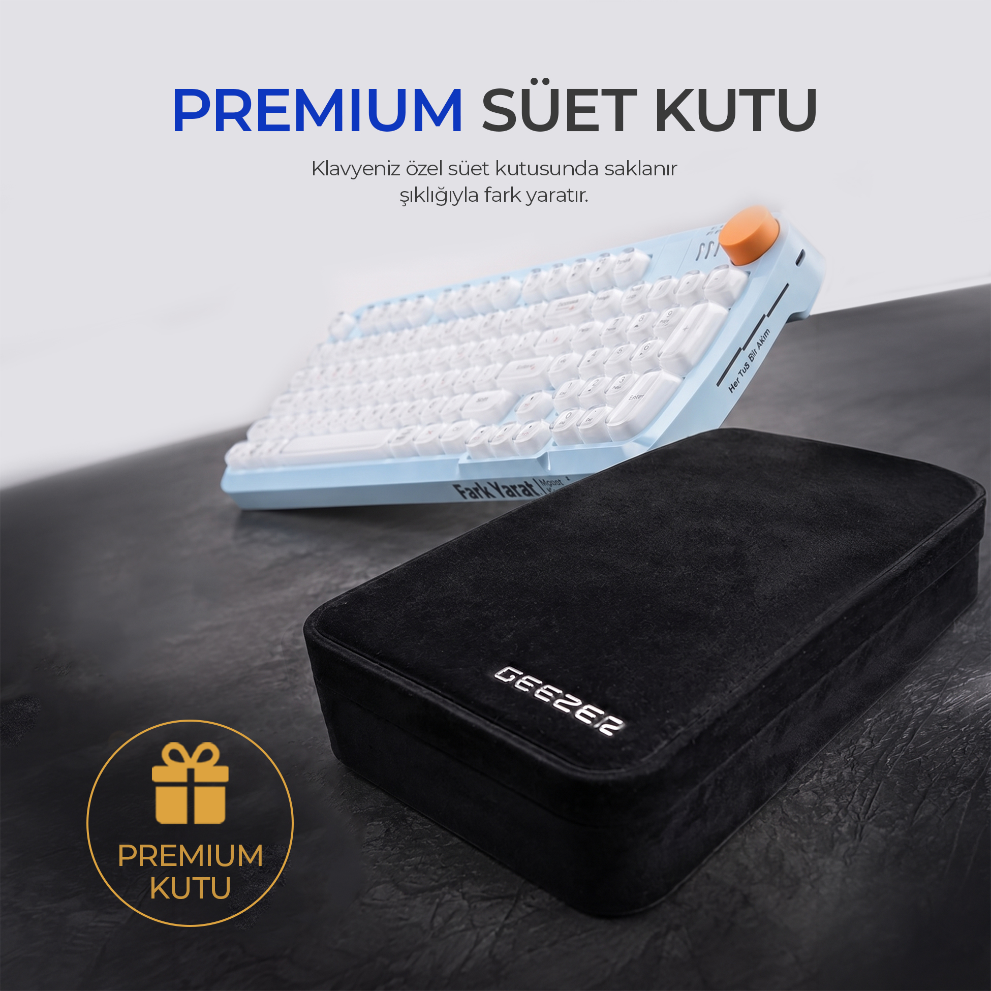 Turuncu tekerlekli mavi klavye ve koyu zeminde şık siyah kadife kutu.