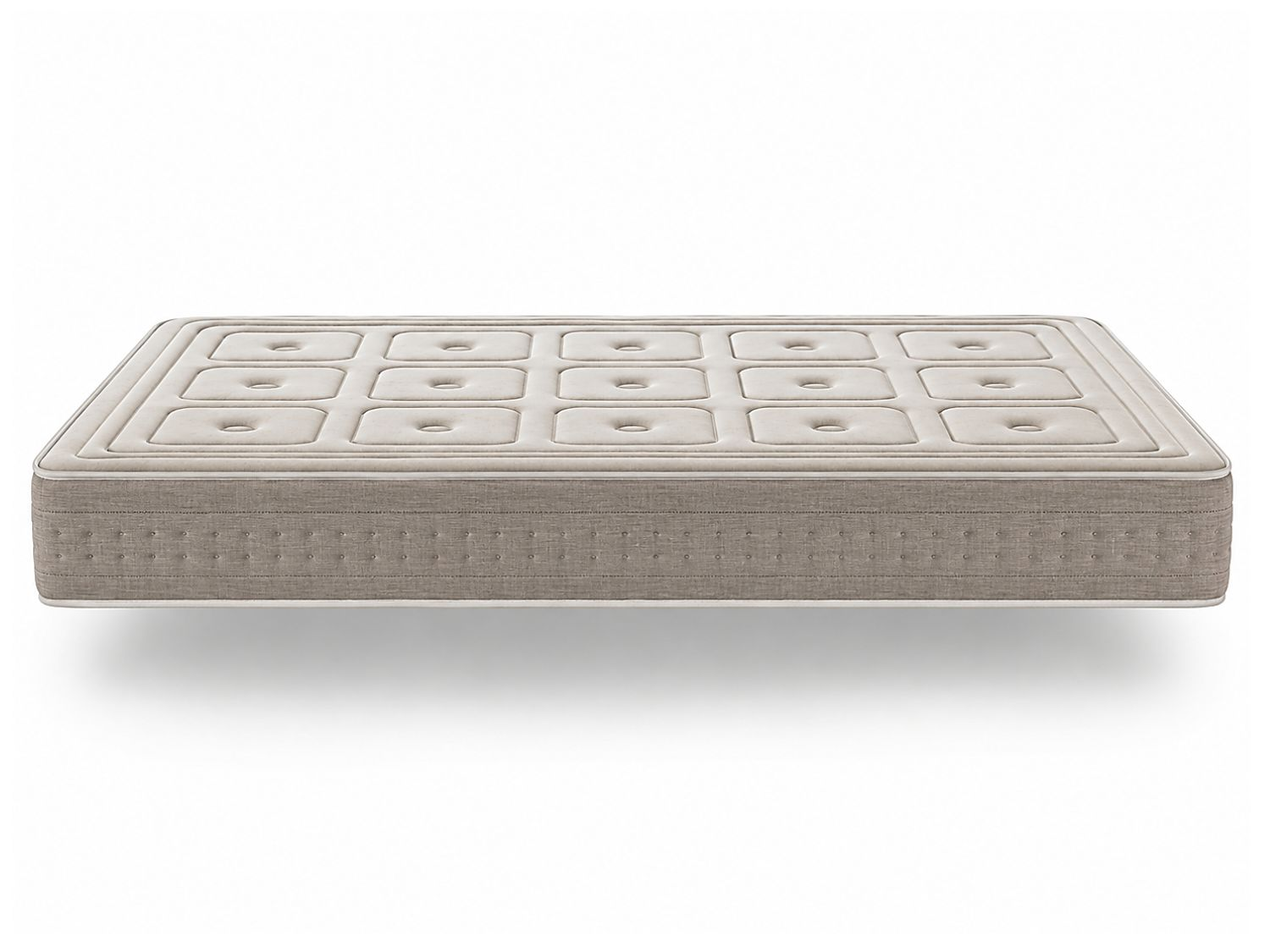 Un colchón capitoné beige flota sobre un fondo blanco.
