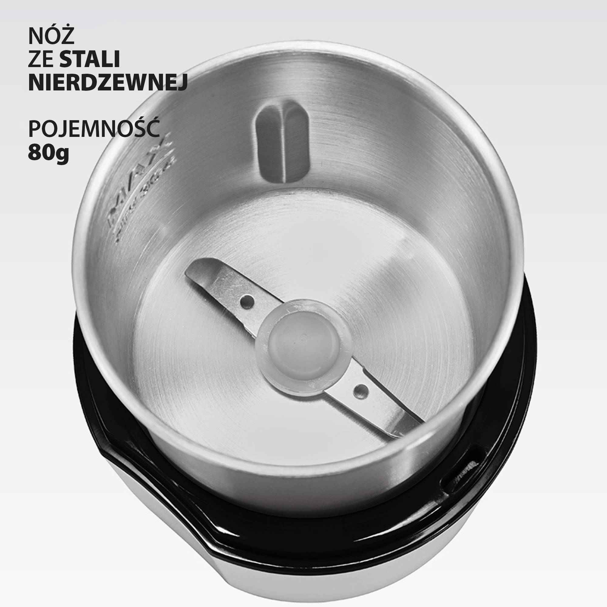 Widok wnętrza młynka ze stali nierdzewnej o pojemności 80g z ostrzem, z polskim tekstem po lewej stronie.