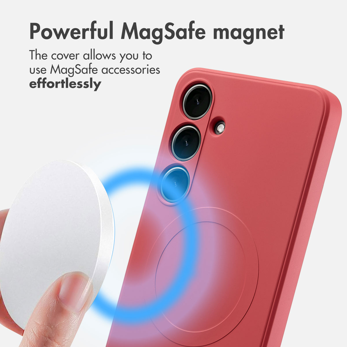 Une main tient un palet magnétique blanc près d'une coque de téléphone rouge.
