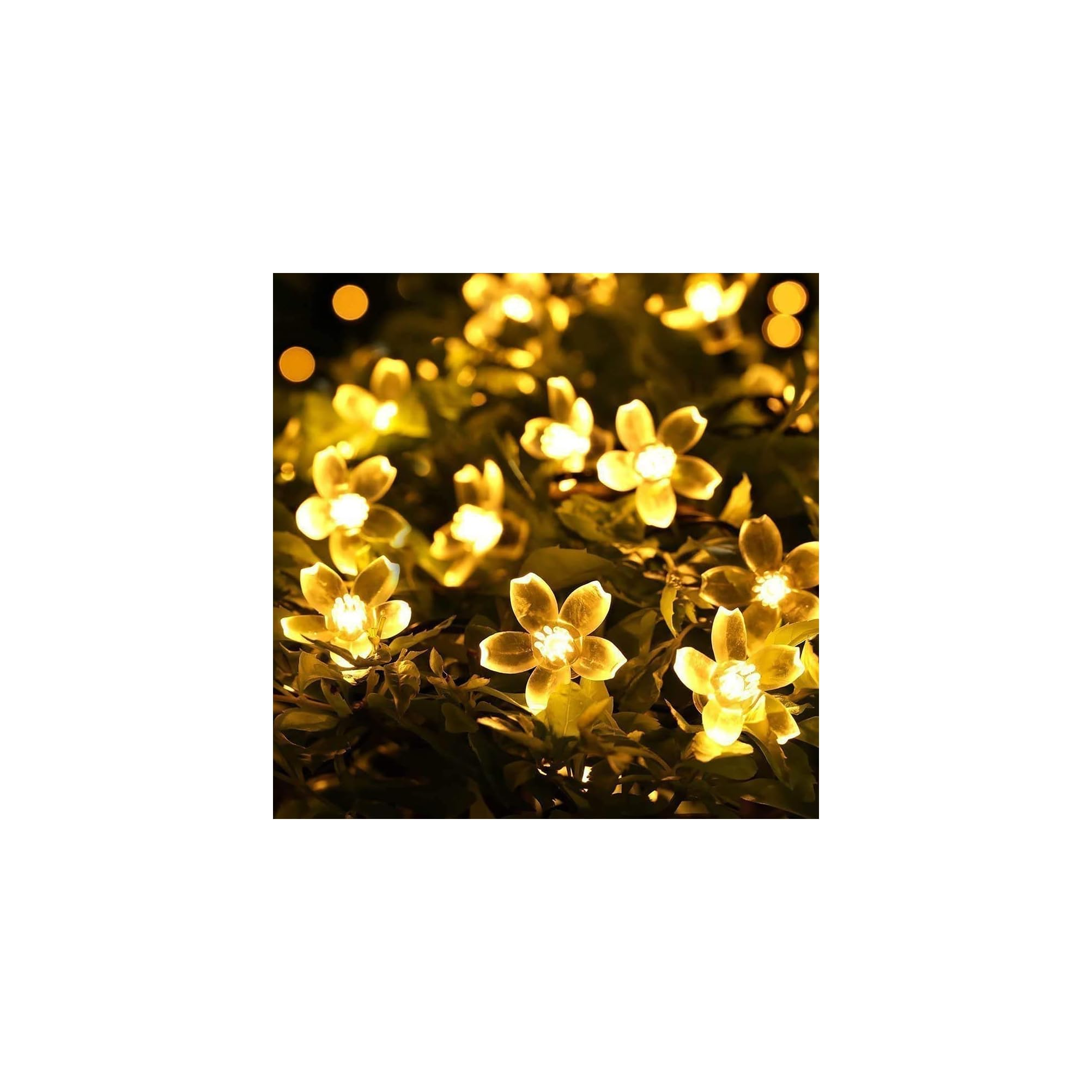 Glühende blumenförmige Lichterketten leuchten in der Dunkelheit.