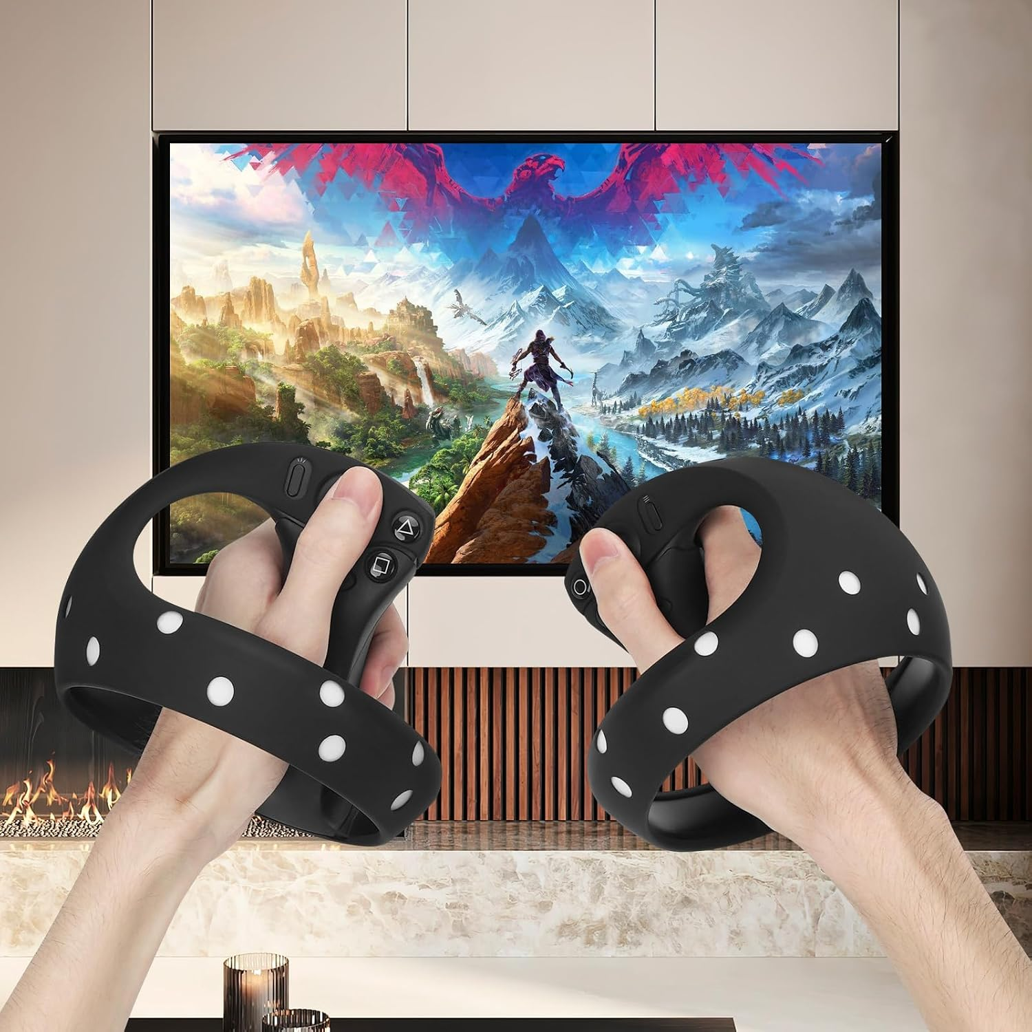 Hände halten schwarze VR-Controller mit weißen Punkten vor einem TV mit Fantasielandschaft.