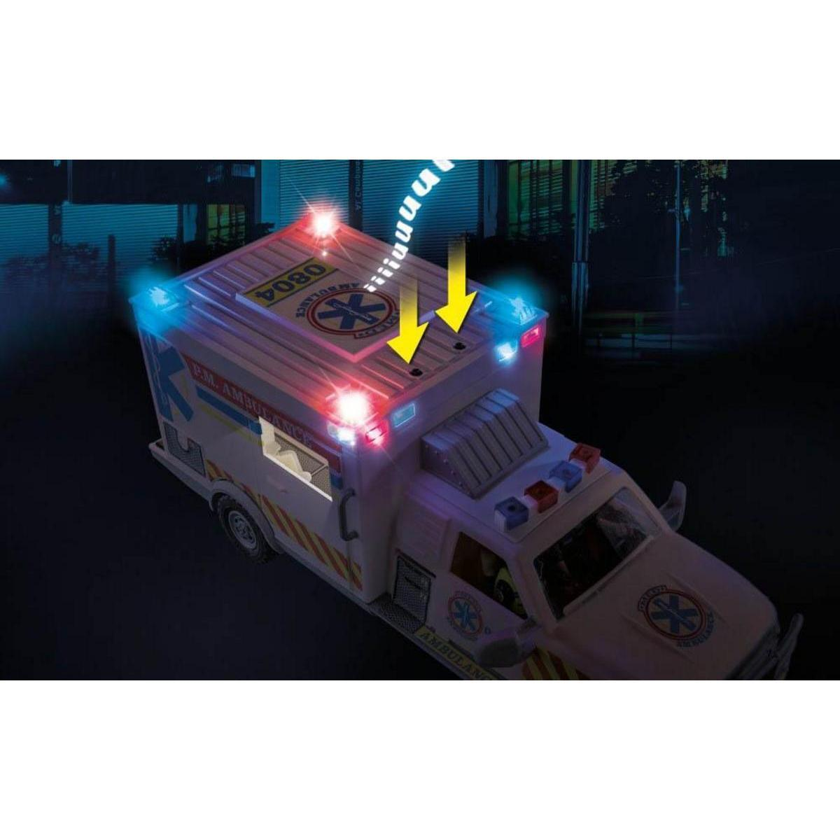 Un vehículo de ambulancia de juguete blanco con luces intermitentes azules y rojas en un entorno nocturno.