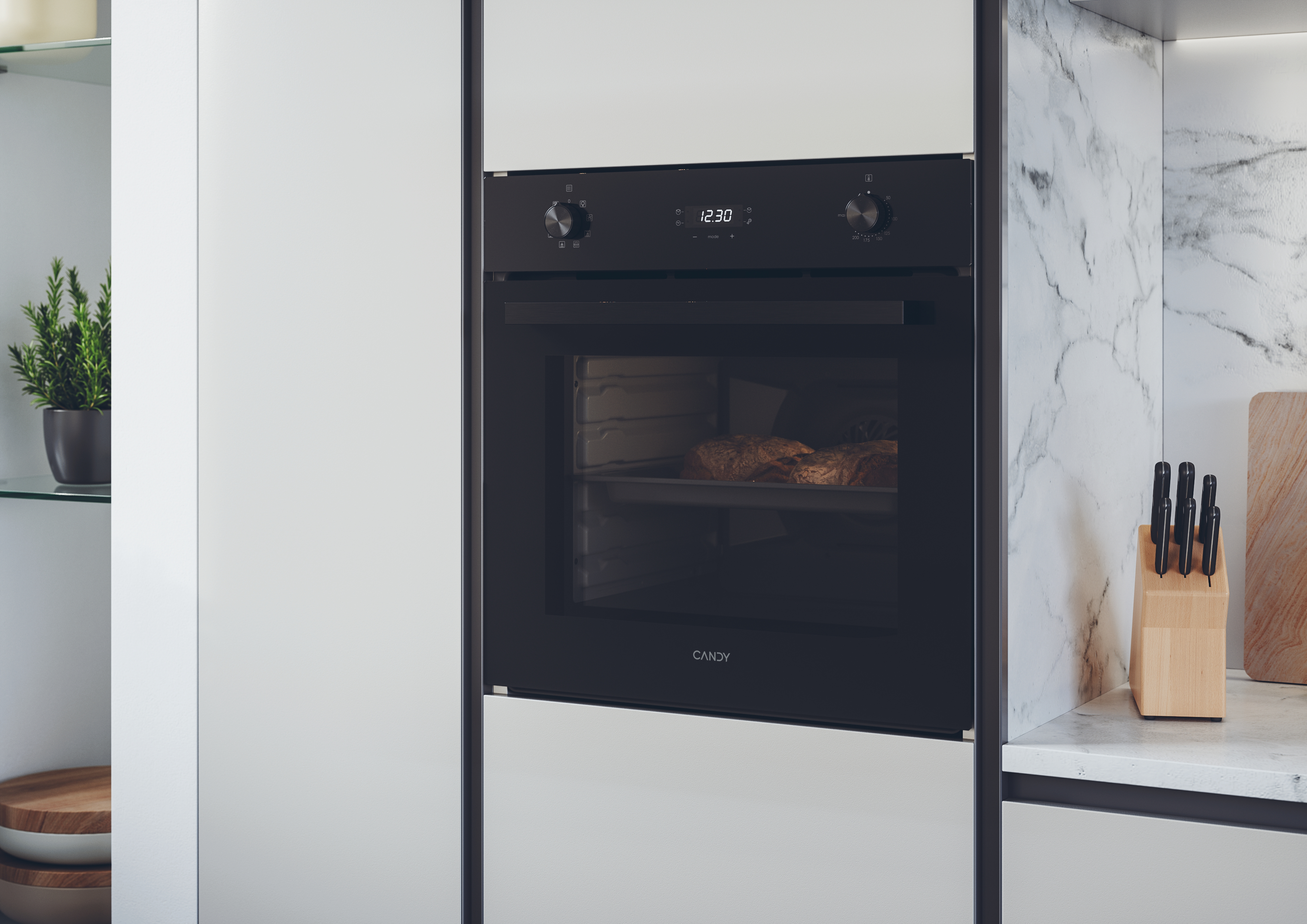 Forno nero Candy da incasso in una moderna cucina bianca con due pagnotte su una teglia.