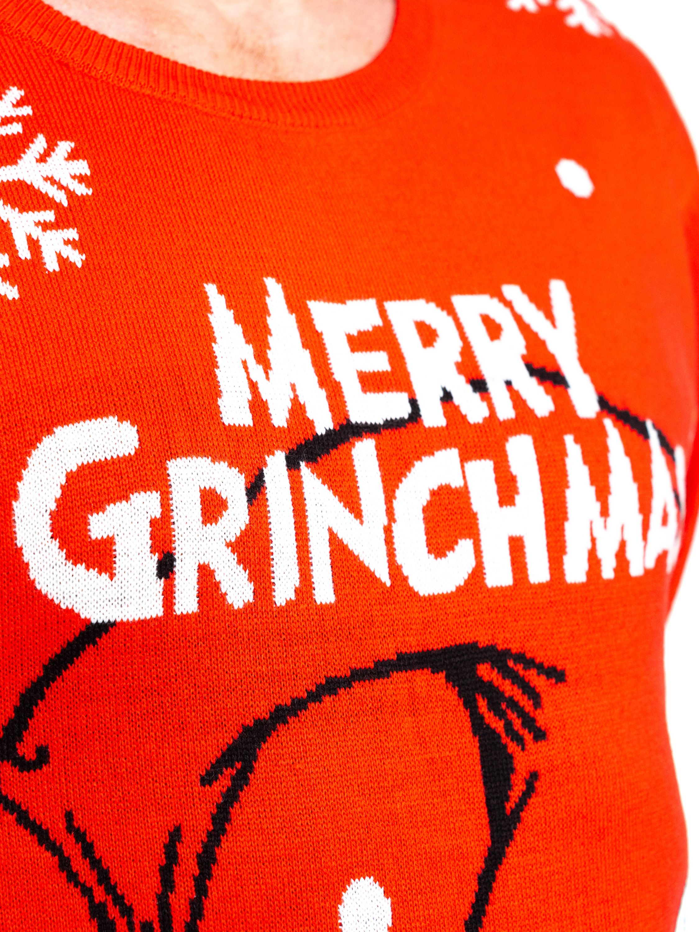 Ein roter Weihnachtspullover mit weißem Text Merry Grinchmas, Schneeflocken und einer schwarzen Grafik.