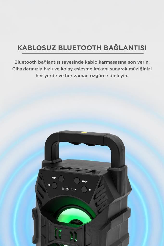 Gri arka plan önünde kulplu ve yeşil LED ışıklı siyah bir Bluetooth hoparlör.