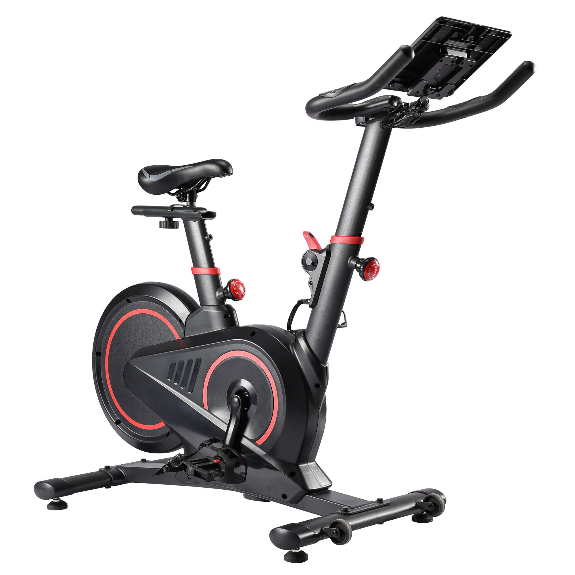 Una bicicleta estática negra con detalles rojos, sillín, pedales, manillar y un soporte para tablet.