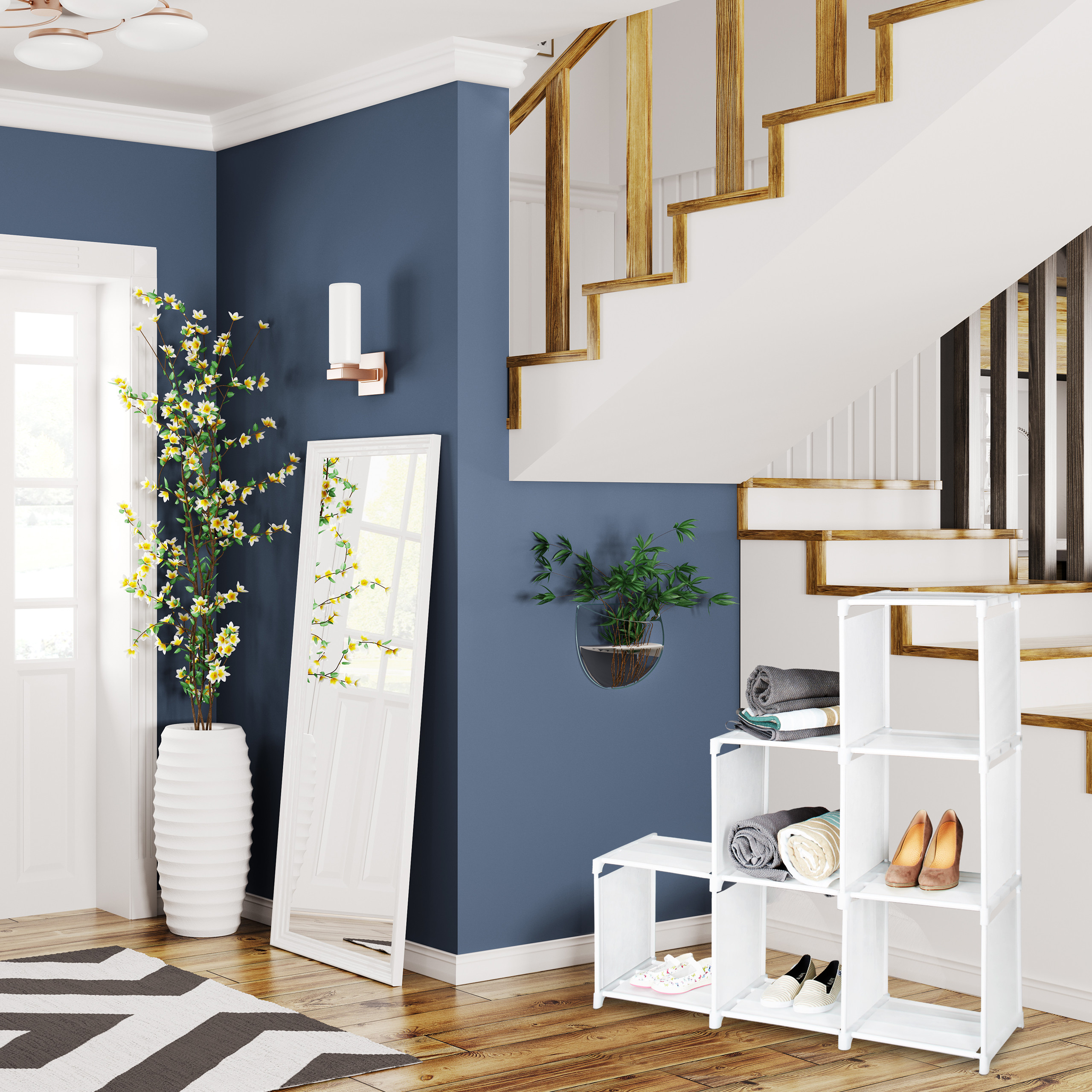 Moderne Eingangshalle mit blauen Wänden, weißer Treppe, Spiegel, Pflanze und weißem Regal mit Schuhen und Decken.