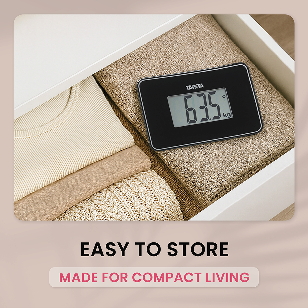 A black Tanita scale on folded clothes inside a white drawer, with text reading "EASY TO STORE".