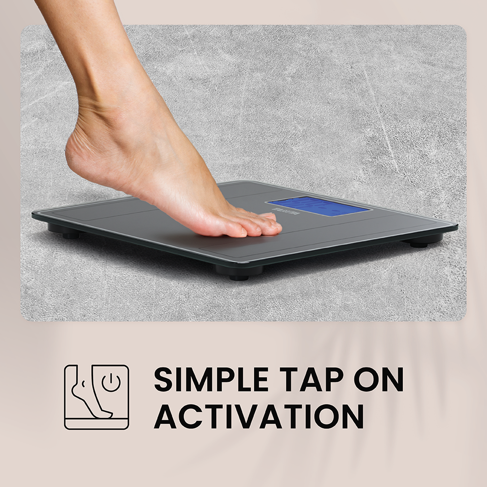 A bare foot taps a grey digital bathroom scale on a stone-colored background, with text.