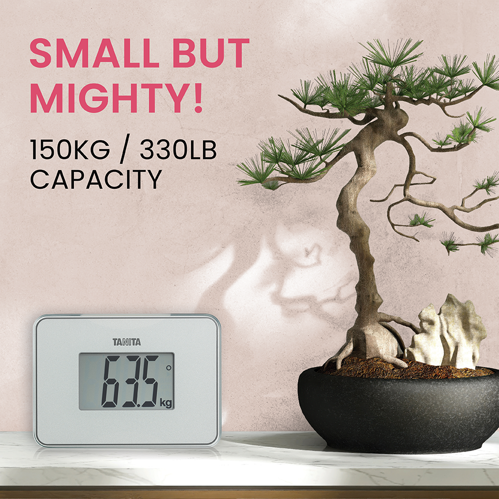 A small digital scale shows 63.5 kg next to a bonsai tree.