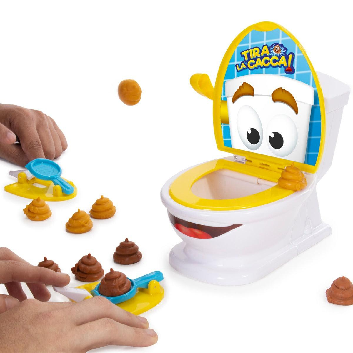 Ein Toilettenspielzeug mit gelben und weißen Plastikteilen, kleinen braunen Figuren und Händen, die sie in die Luft schnellen.