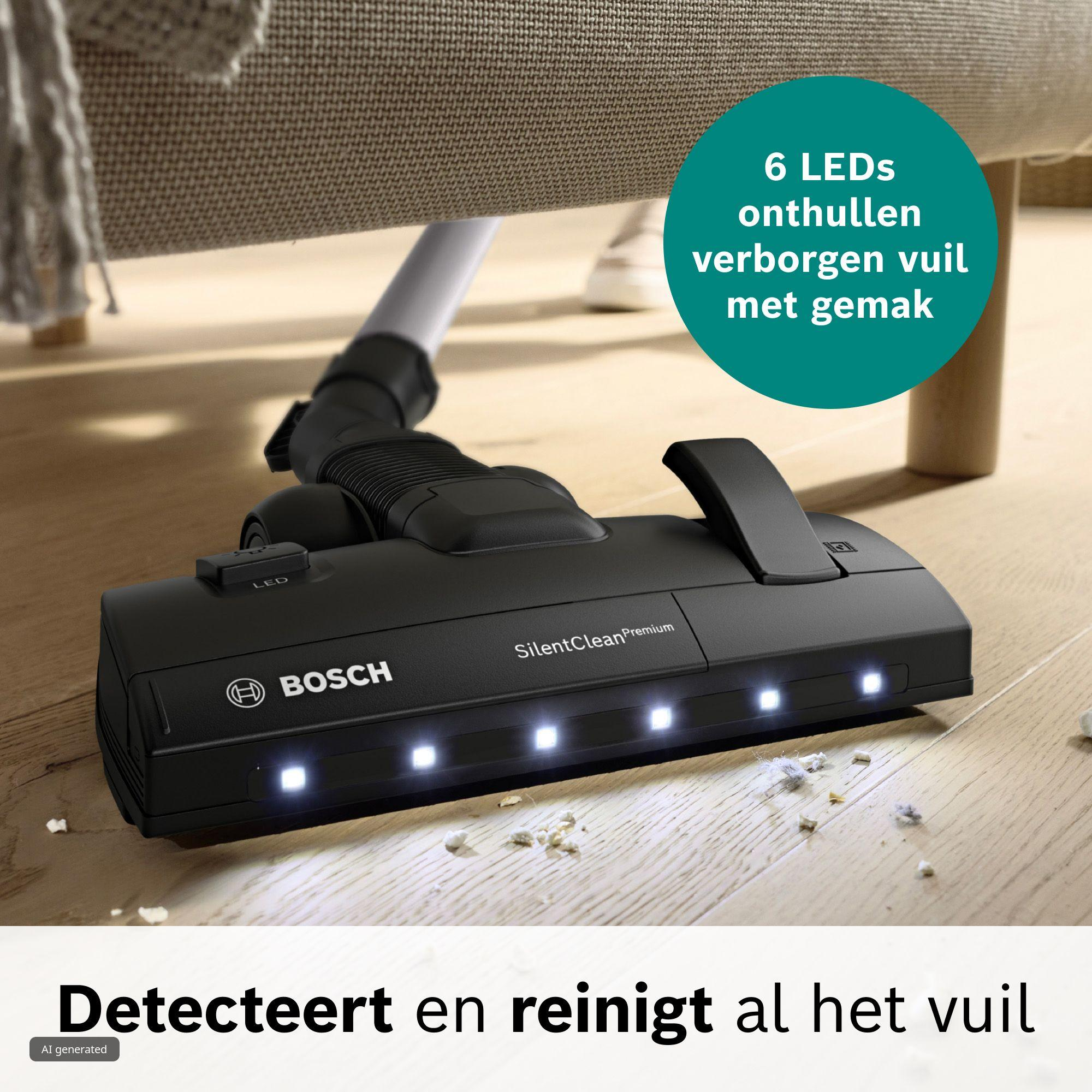 Een zwarte Bosch stofzuigermond met zes brandende led-lampjes reinigt vuil onder een bank op houten vloer.