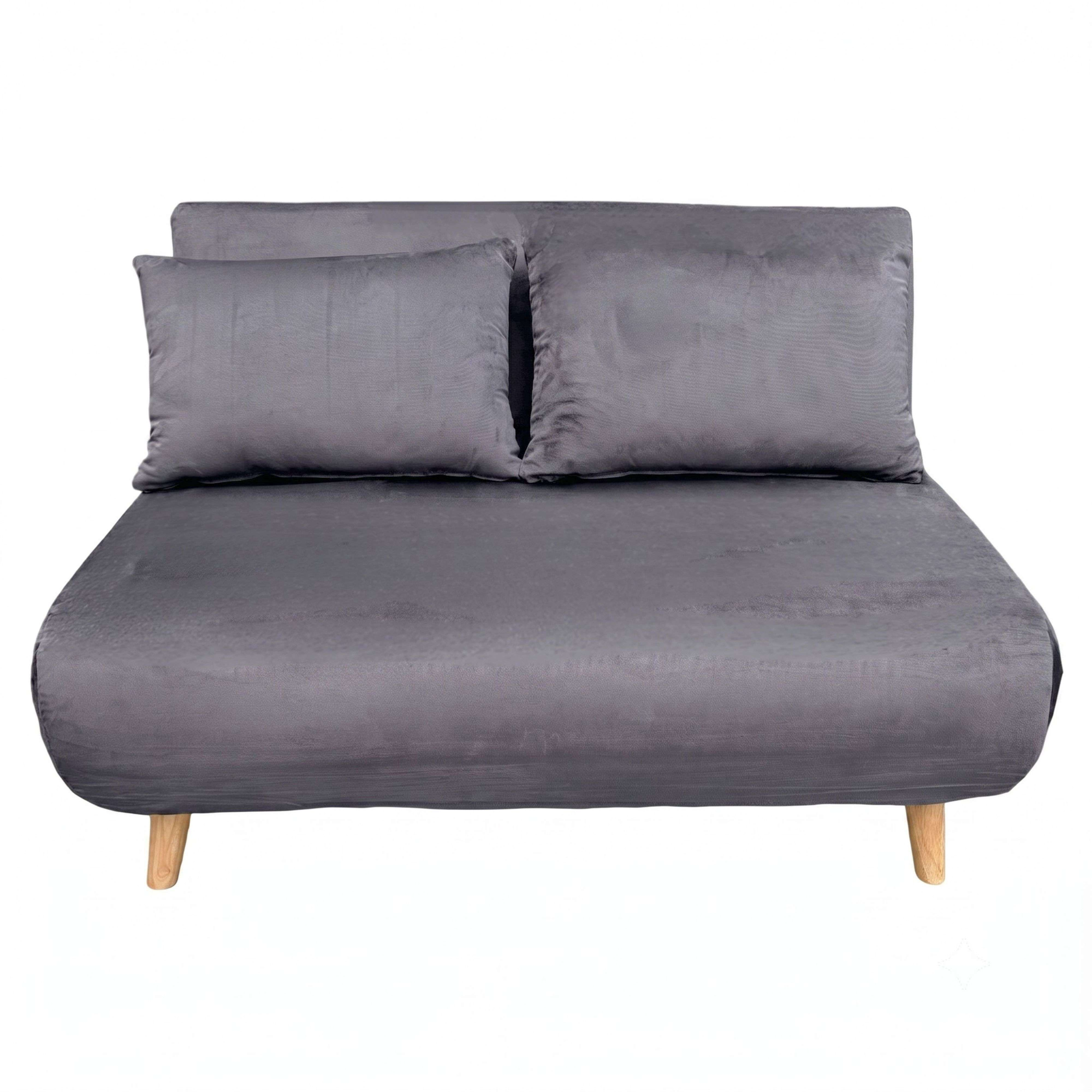 Un sofá cama gris con dos cojines a juego y patas de madera clara sobre fondo blanco.