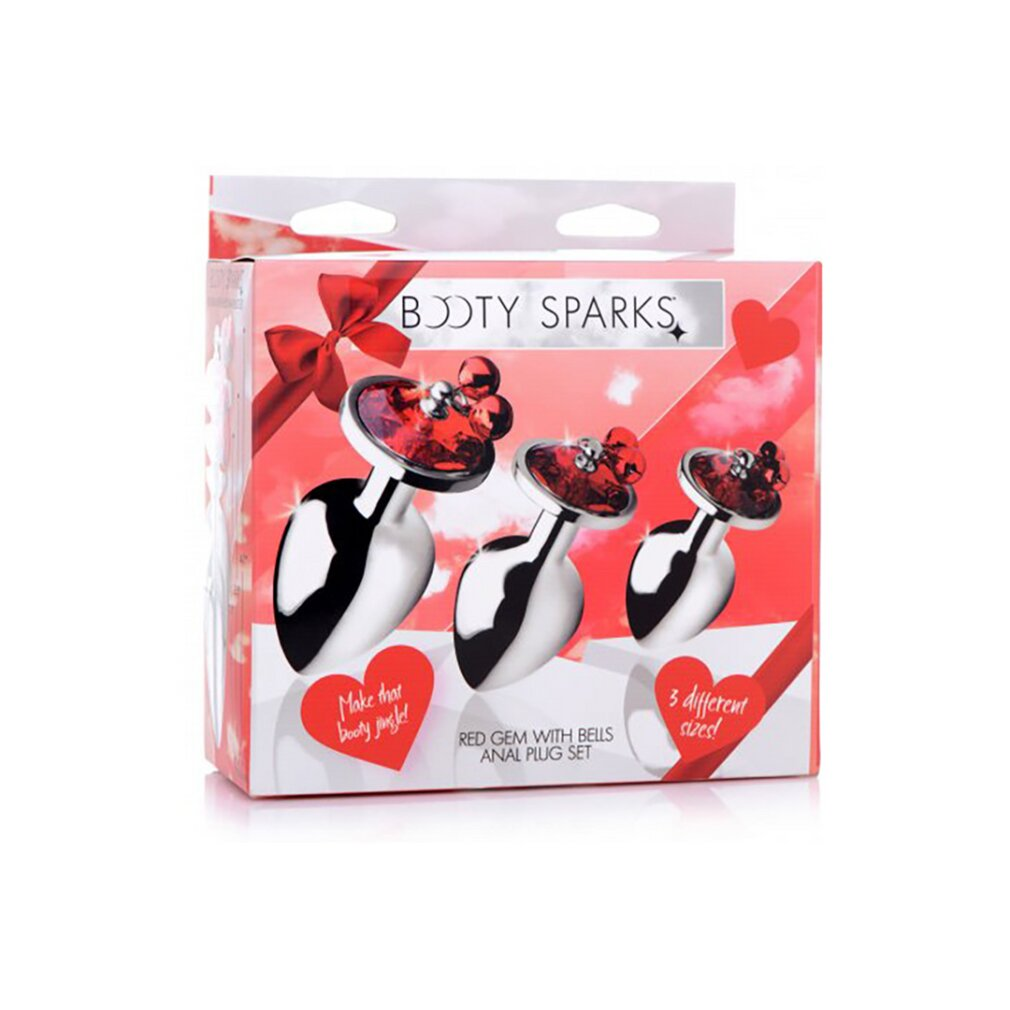 Booty Sparks Set mit drei silbernen Analstöpseln, roten Schmucksteinen und Glöckchen in einer Box.