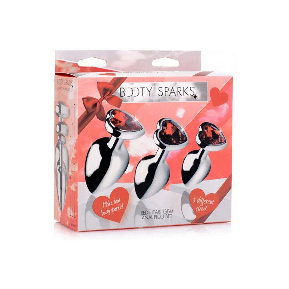 Verpackung eines Booty Sparks Analplug-Sets mit drei Plug-Größen mit roten Herzsteinen vor rosa Hintergrund.