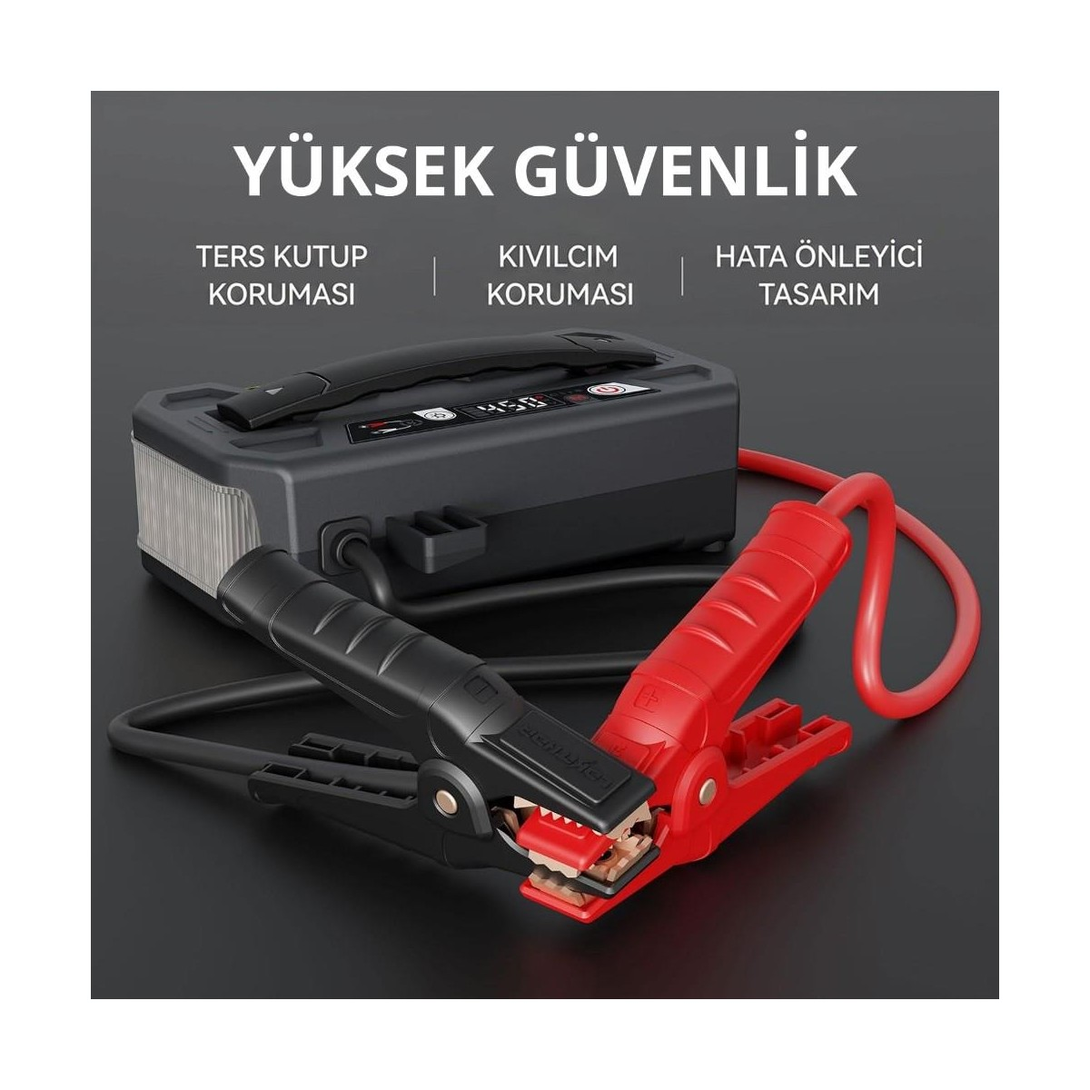 Gri arka plan önünde kırmızı ve siyah penslere sahip dijital ekranlı taşınabilir akü takviye cihazı.