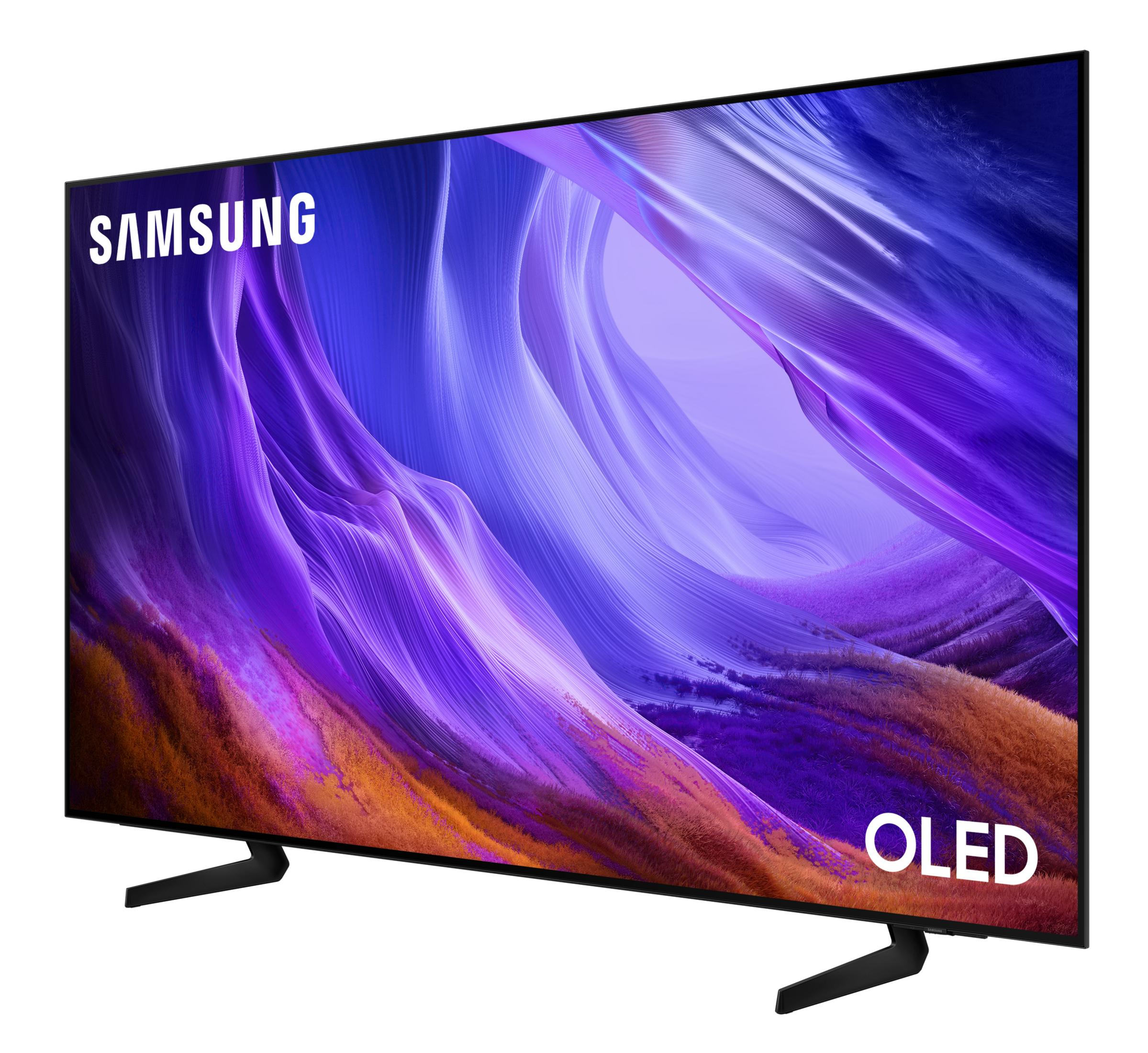 Un téléviseur OLED Samsung sur pieds noirs affiche un fond d'écran abstrait violet et orange vif.