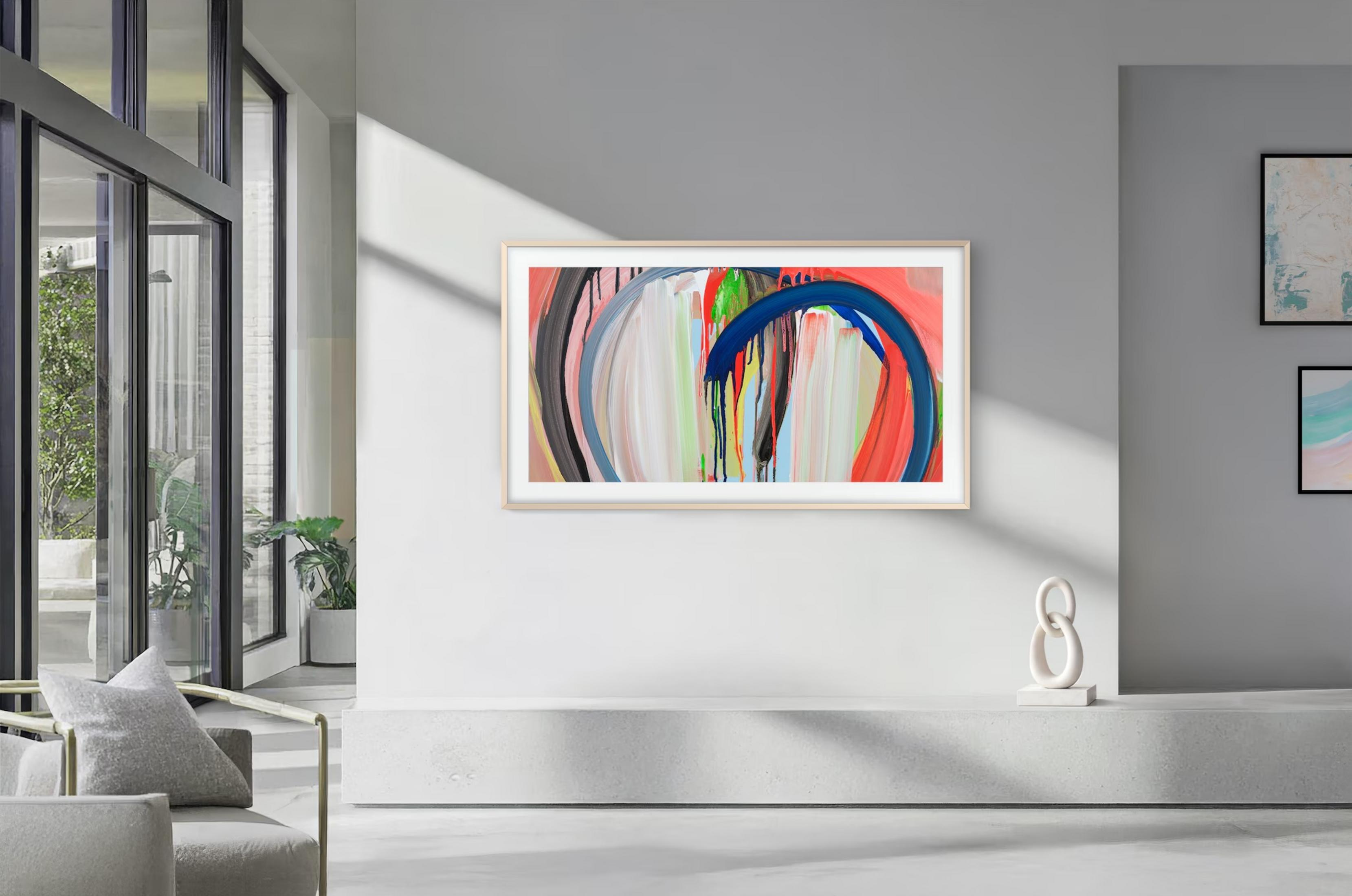 Une peinture abstraite encadrée avec des coups de pinceau bleus et rouges est accrochée au mur.