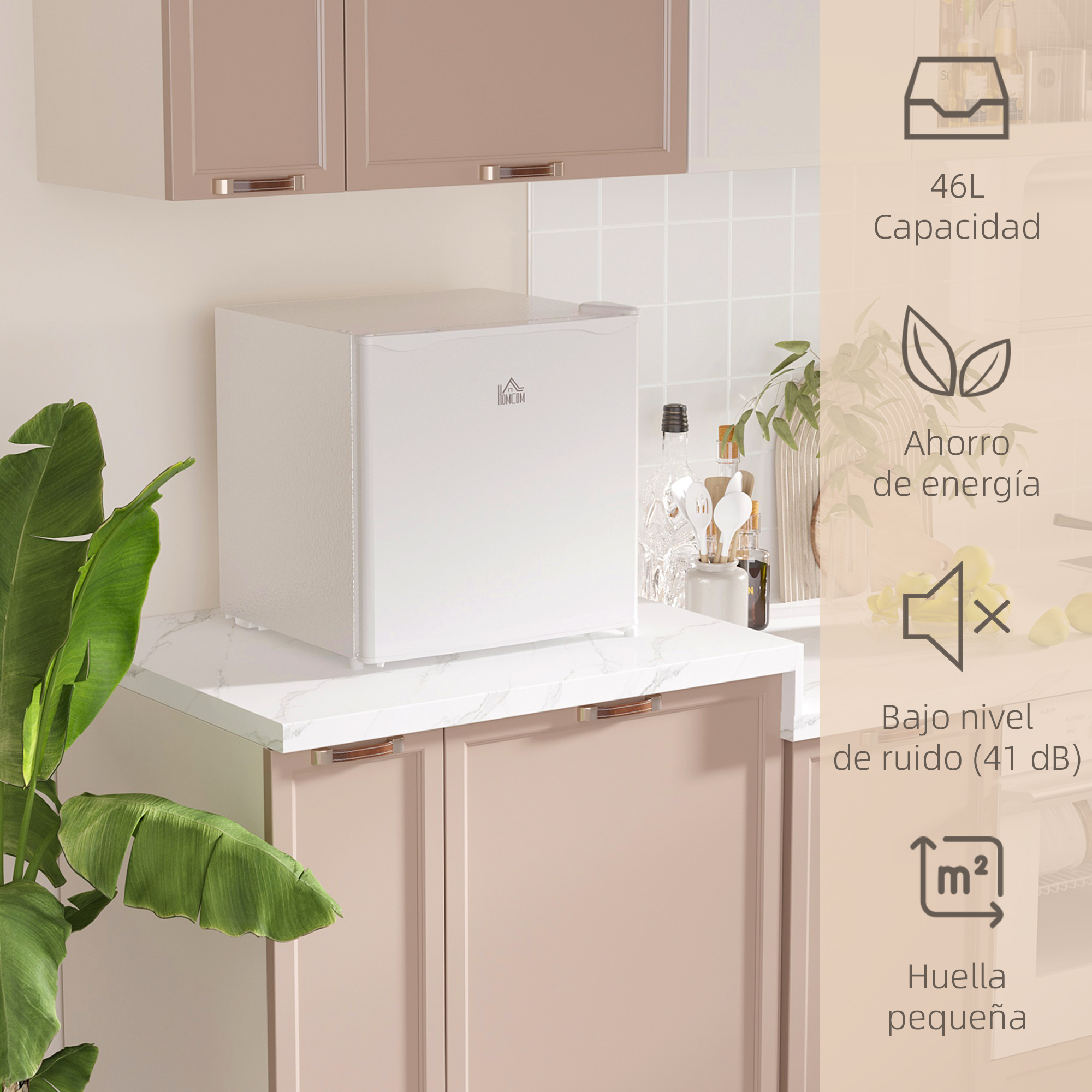 Mininevera blanca compacta en una encimera de cocina con armarios rosados e iconos a la derecha.